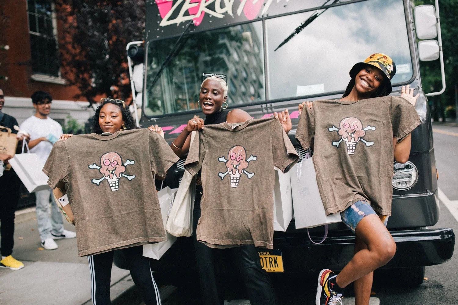 Fans holding up ICECREAM x Smino capsule T-shirts at the launch