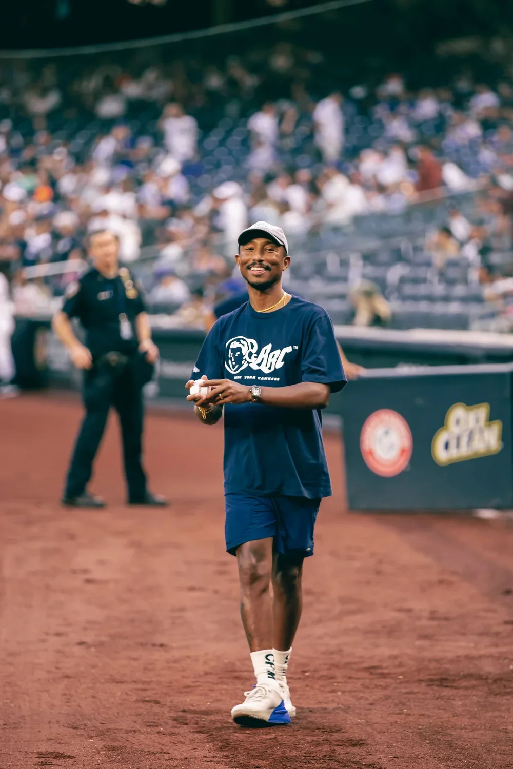 Pharrell Williams on the field at Yankee Stadium for the collaboration's ceremonial first pitch