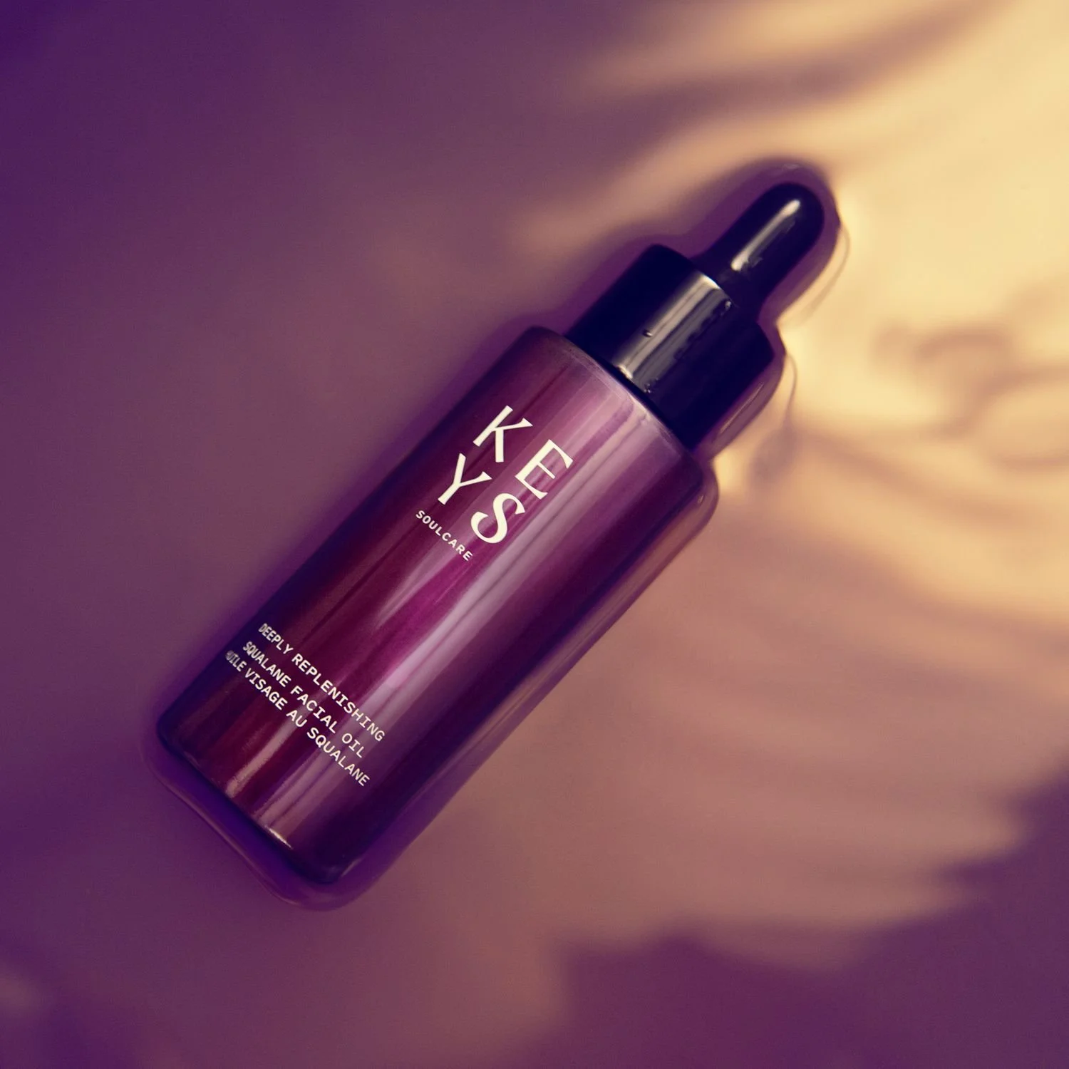 Keys Soulcare facial oil bottle in purple light
