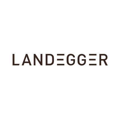 Das Bild zeigt ein Logo mit dem Text 'LANDegger' auf schwarz. Über dem Text sind drei stilisierte Bäume oder Fichten. Das Logo wirkt modern und minimalistisch.