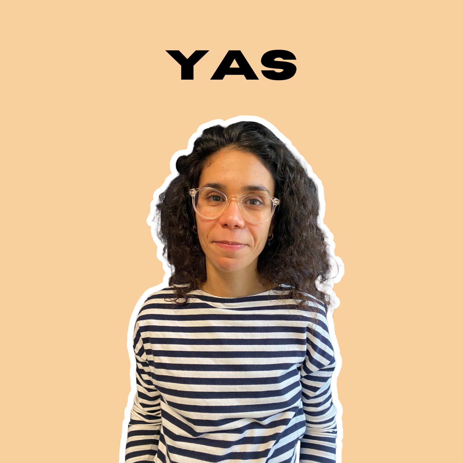A woman with curly dark hair, wearing clear glasses and a striped black and white shirt, standing against a beige background with the text 'YAS' above her head.