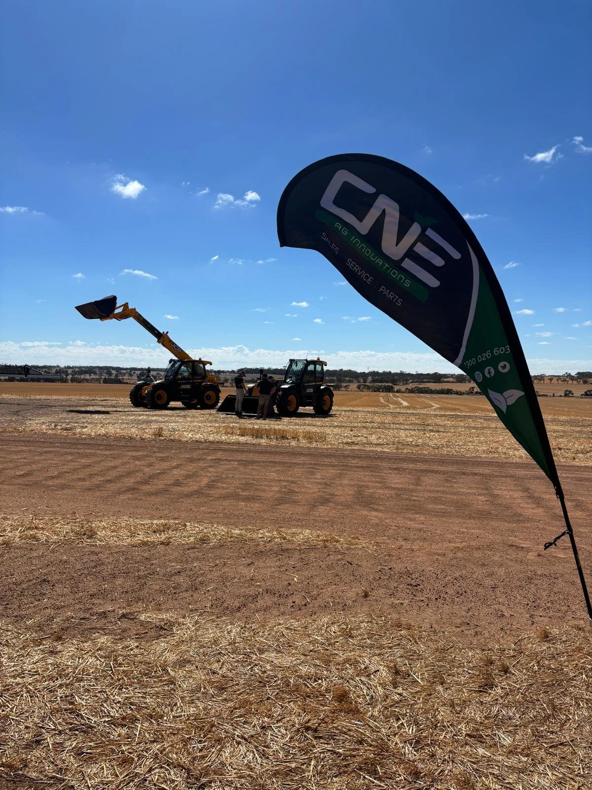 CNE Ag Innovations flag at a paddock demo with a JCB telehandler