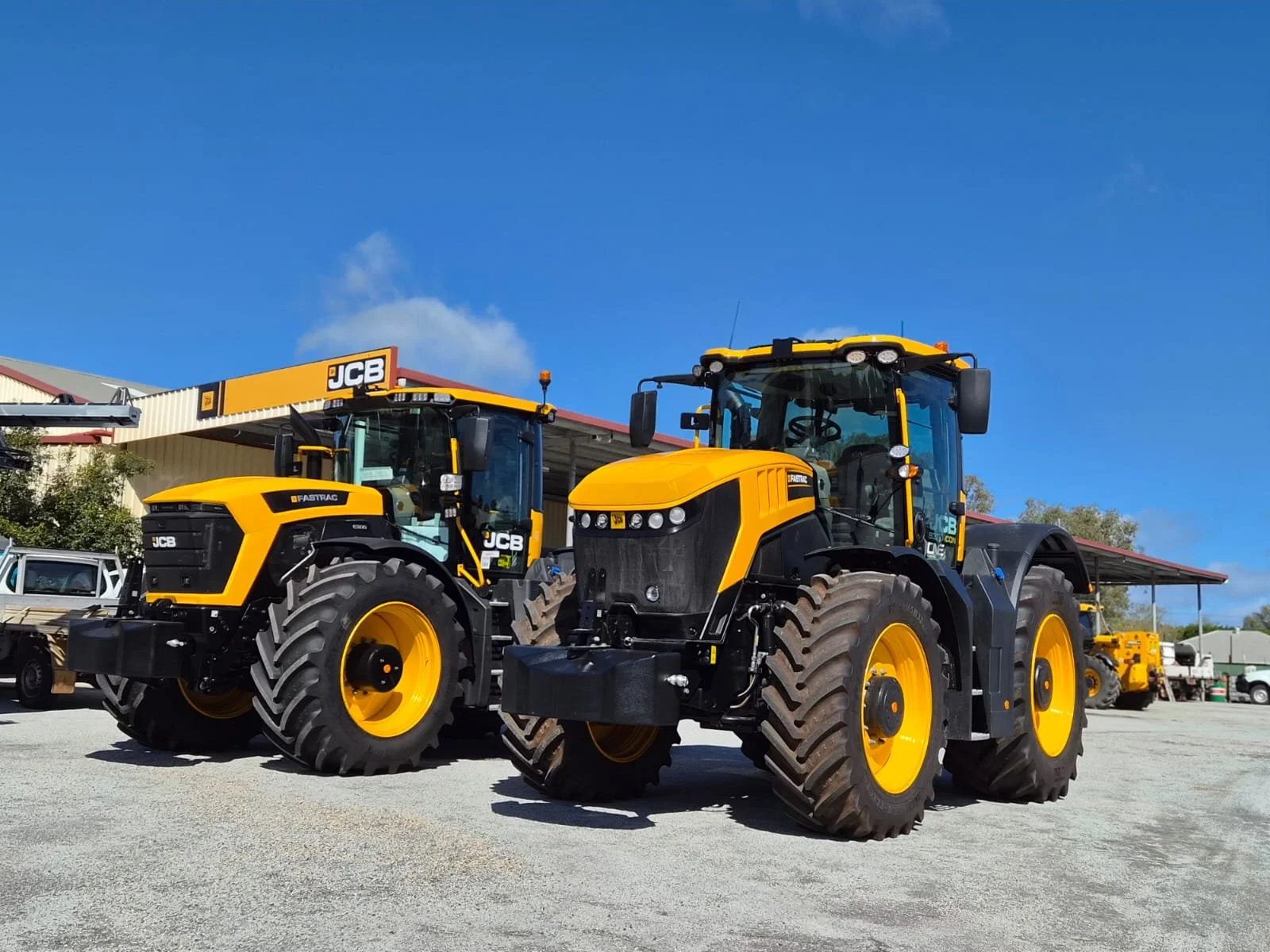 Two JCB Fastrac tractors in a dealership yard
