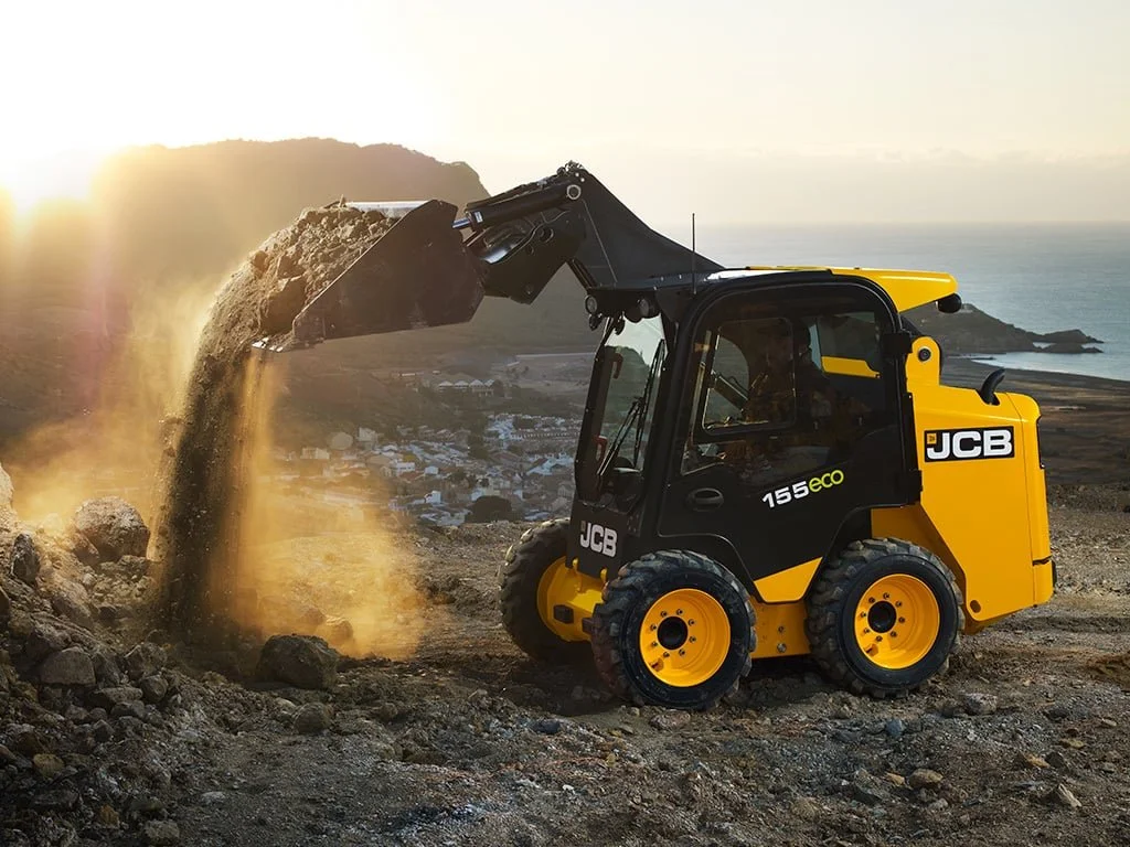 JCB 155 skid steer loader tipping soil from its bucket
