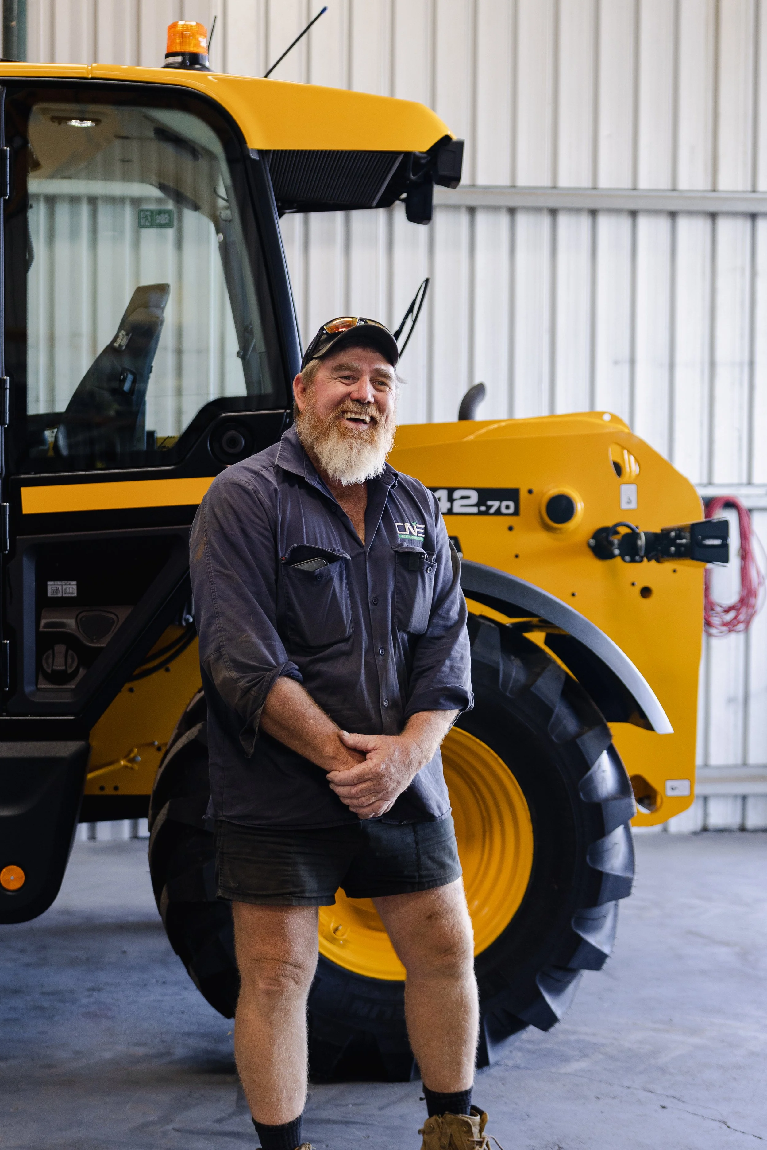 CNE Ag Innovations service technician with a JCB telehandler in the workshop