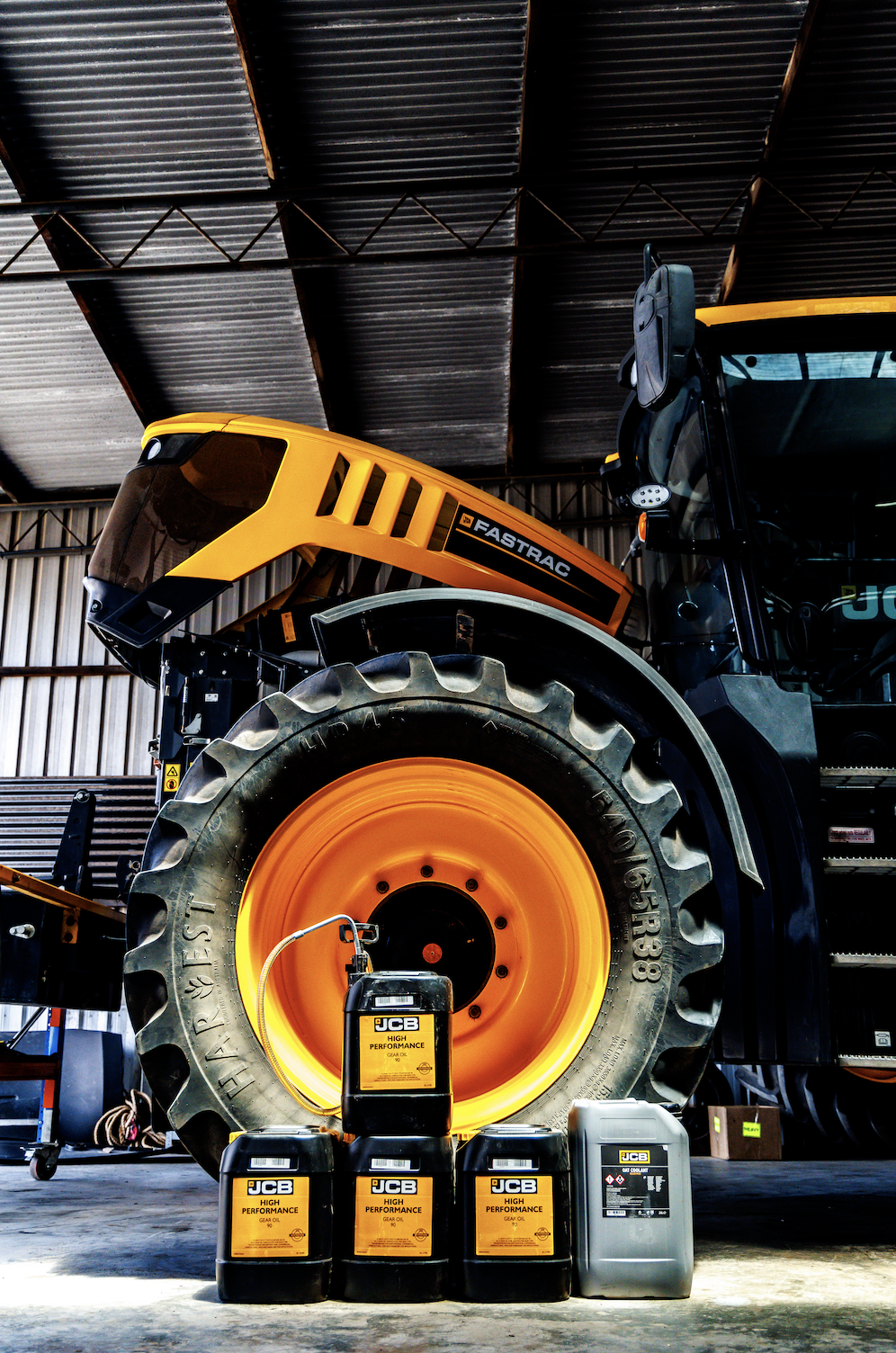 JCB oils and lubricants beside a JCB Fastrac tractor in the workshop