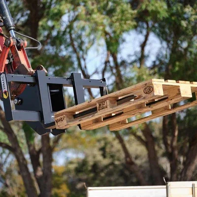 HIMAC excavator pallet forks lifting a timber pallet