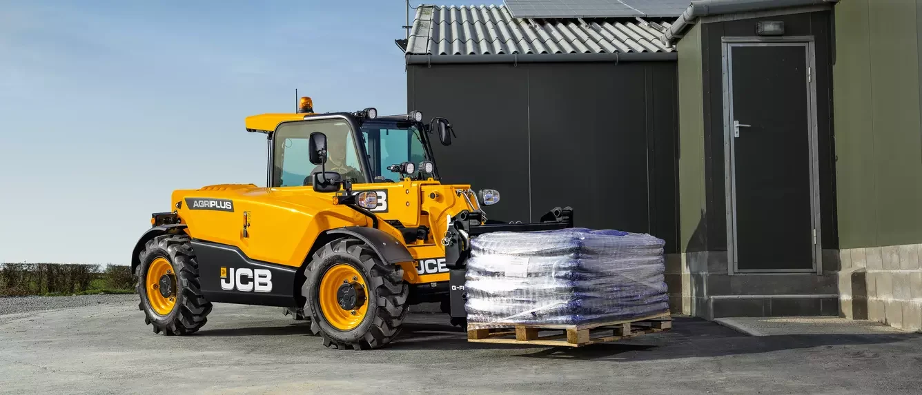 JCB 525-60 Agri telehandler moving a pallet of bagged product