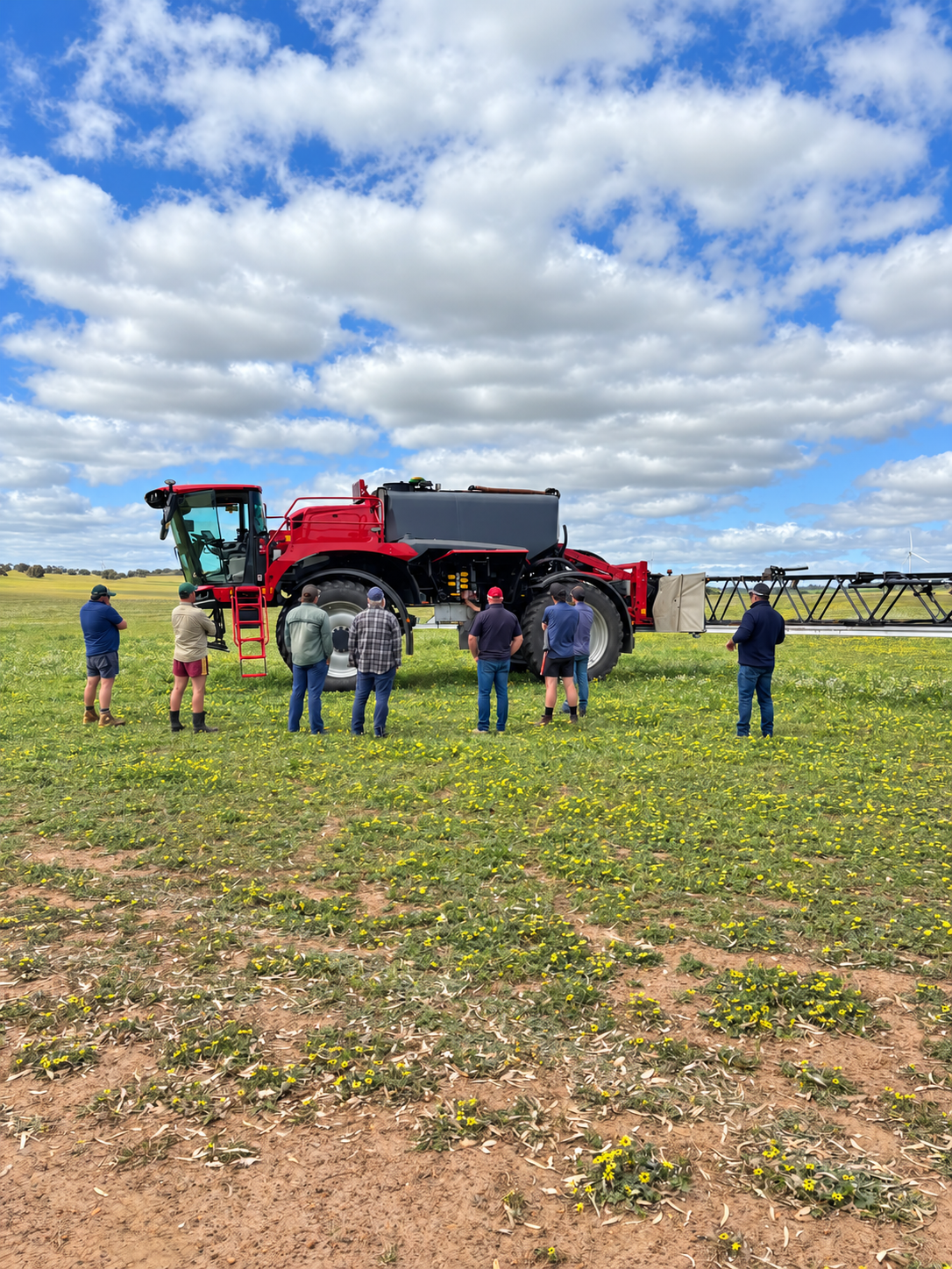 Growers inspecting a HORSCH sprayer in a paddock