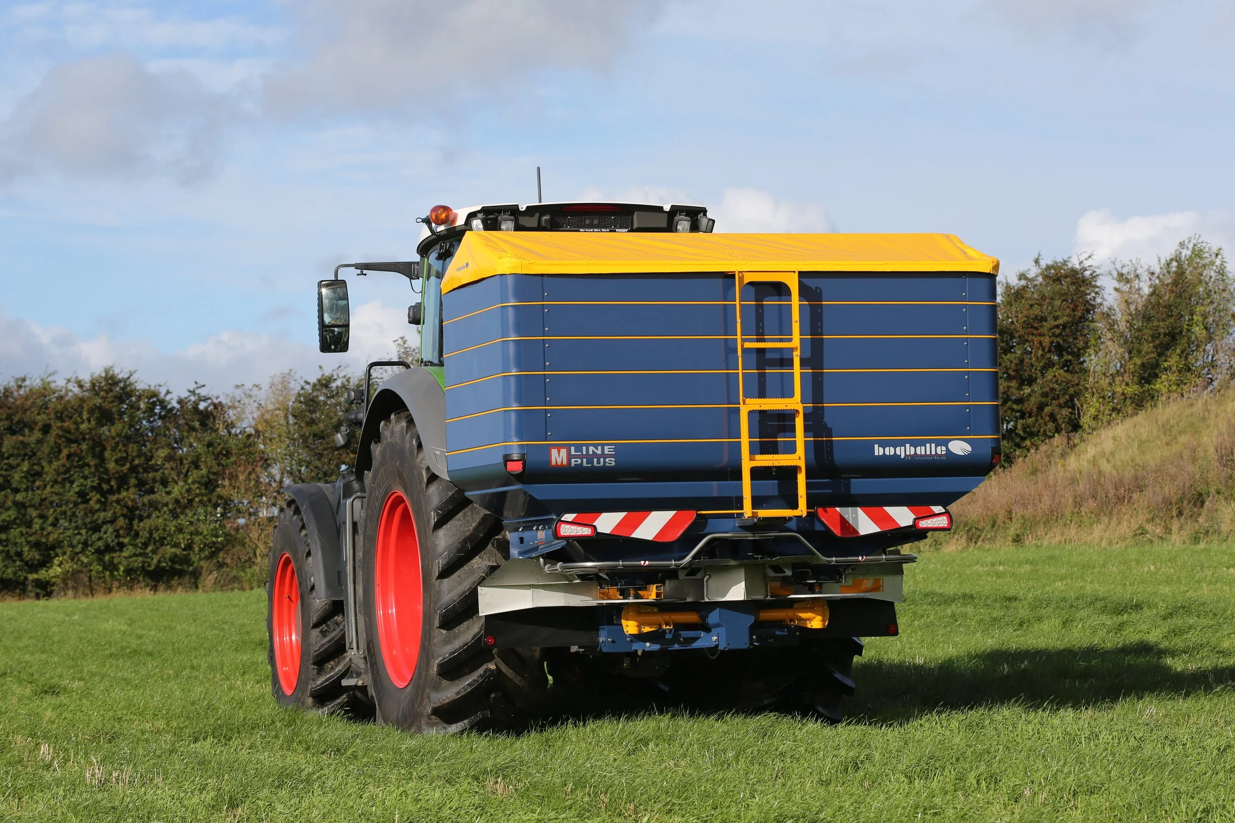 Bogballe fertiliser spreader mounted on a tractor in a grass paddock