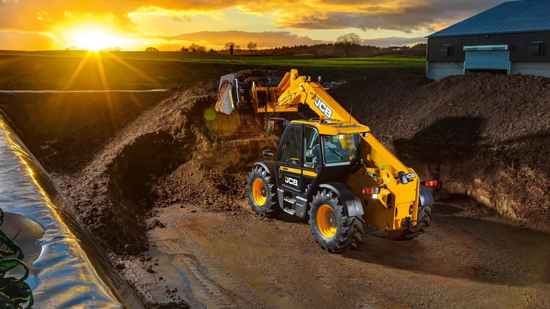 JCB 542-70 Agri Pro telehandler working a silage pile at sunset