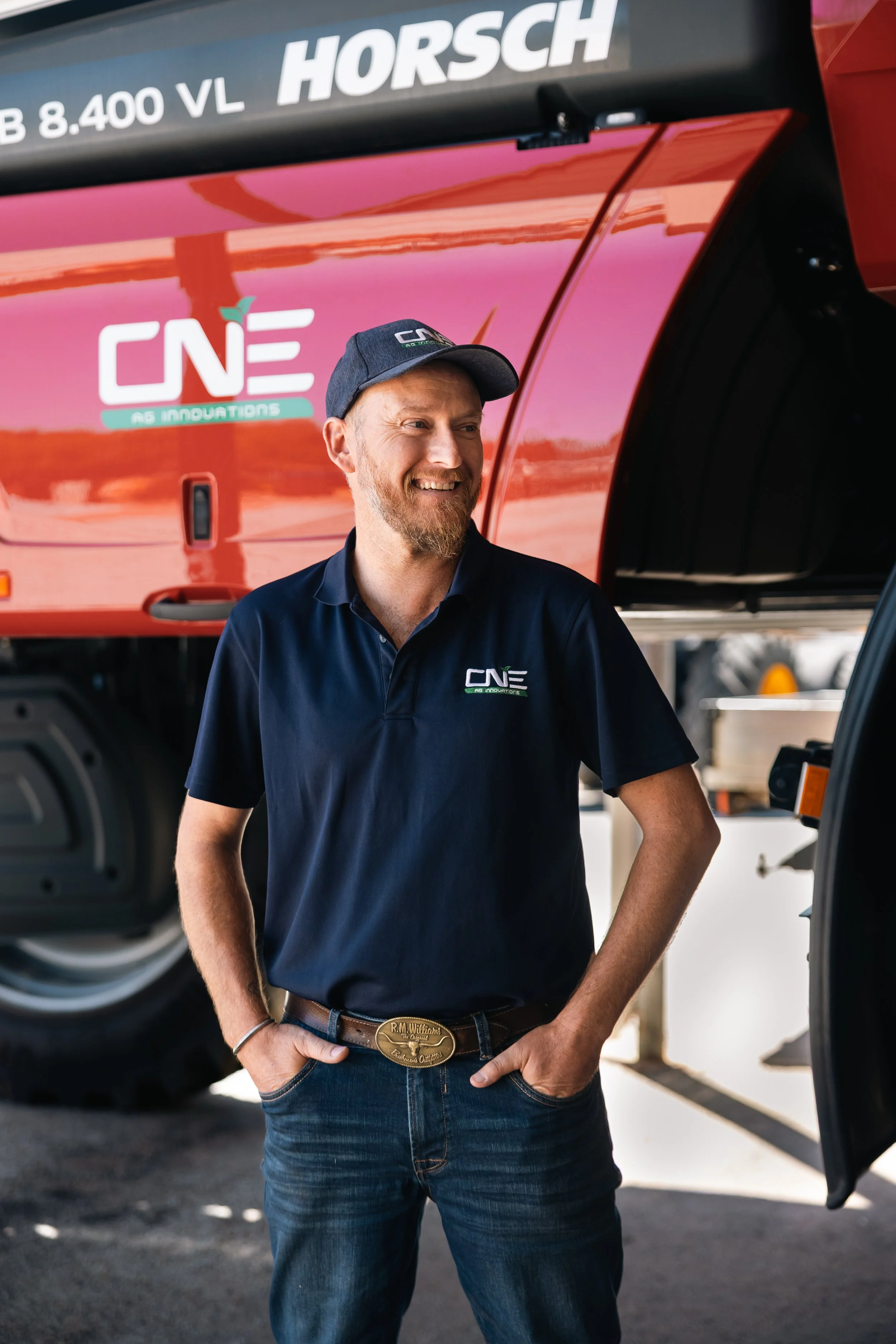 CNE Ag Innovations team member beside a HORSCH Leeb sprayer