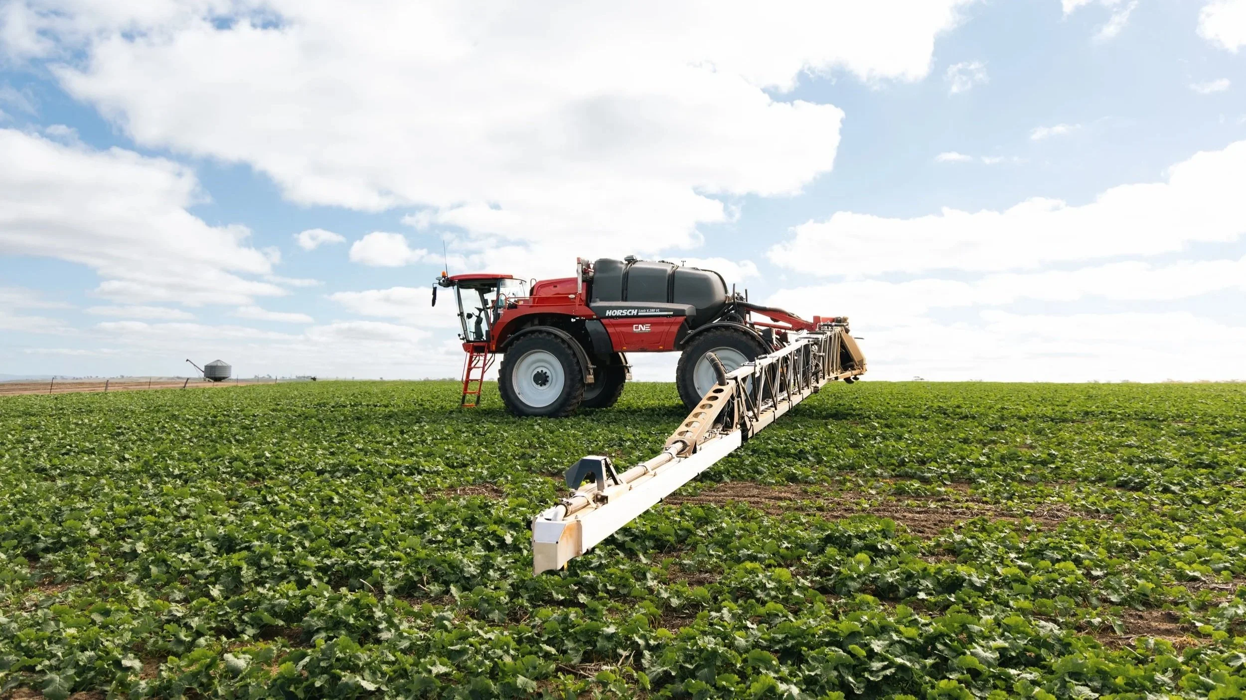 HORSCH self-propelled sprayer with boom extended over a green crop