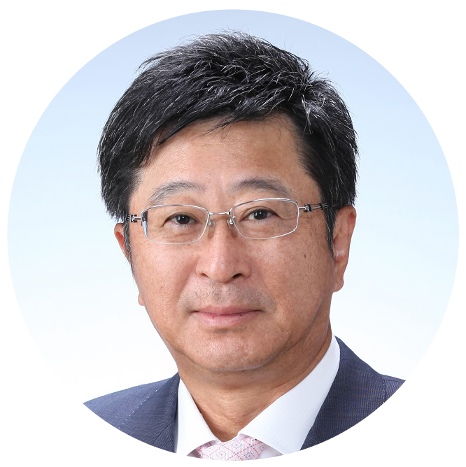 Portrait of a middle-aged Asian man wearing glasses, a navy suit, and a white shirt with a light pink tie, against a plain light blue background.