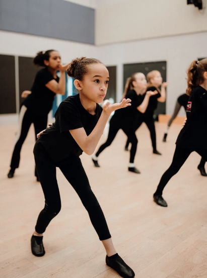 Young performer taking part in a drama exercise during a Stroud Theatre Arts performing arts class.