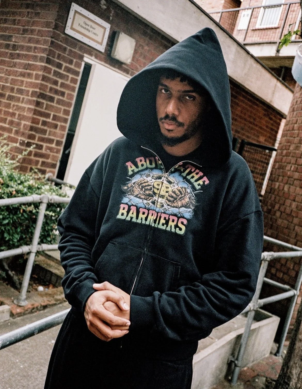 AJ Tracey wearing 99byJMS x Barriers NY collaboration for the press release