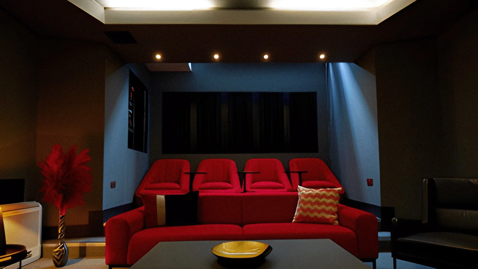 A modern theater room with red theater seats, a red sofa with a chevron throw pillow, a gray coffee table with a yellow bowl, and a dark wall with a black picture frame. There is a red and black vase with red feathers on the left side.