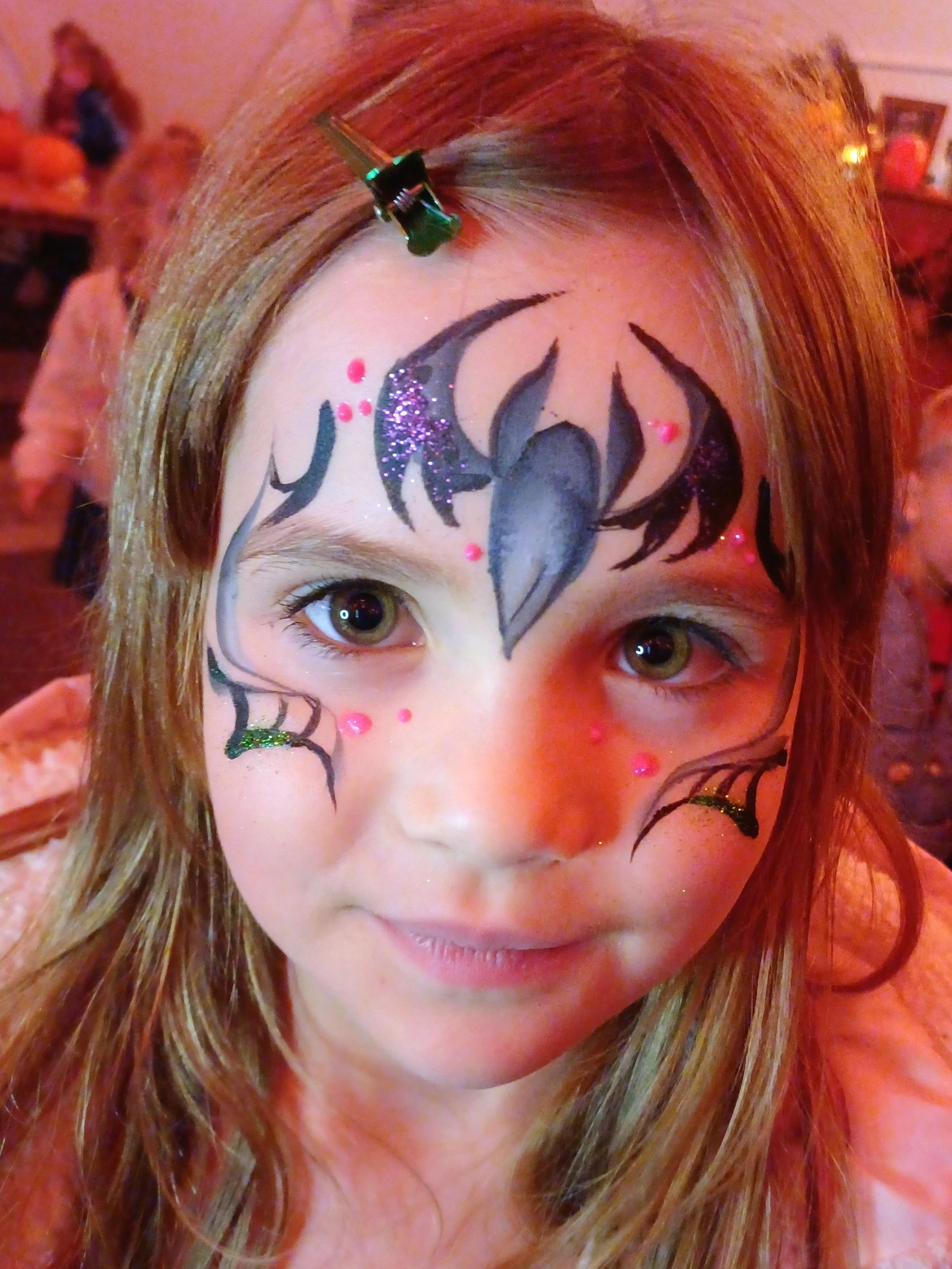 A girl with halloween bat face paint