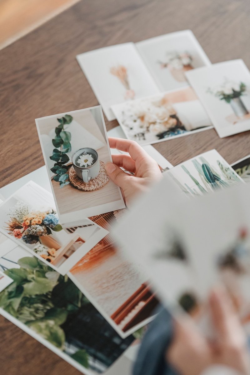 Printed photographs being arranged for a creative moodboard.