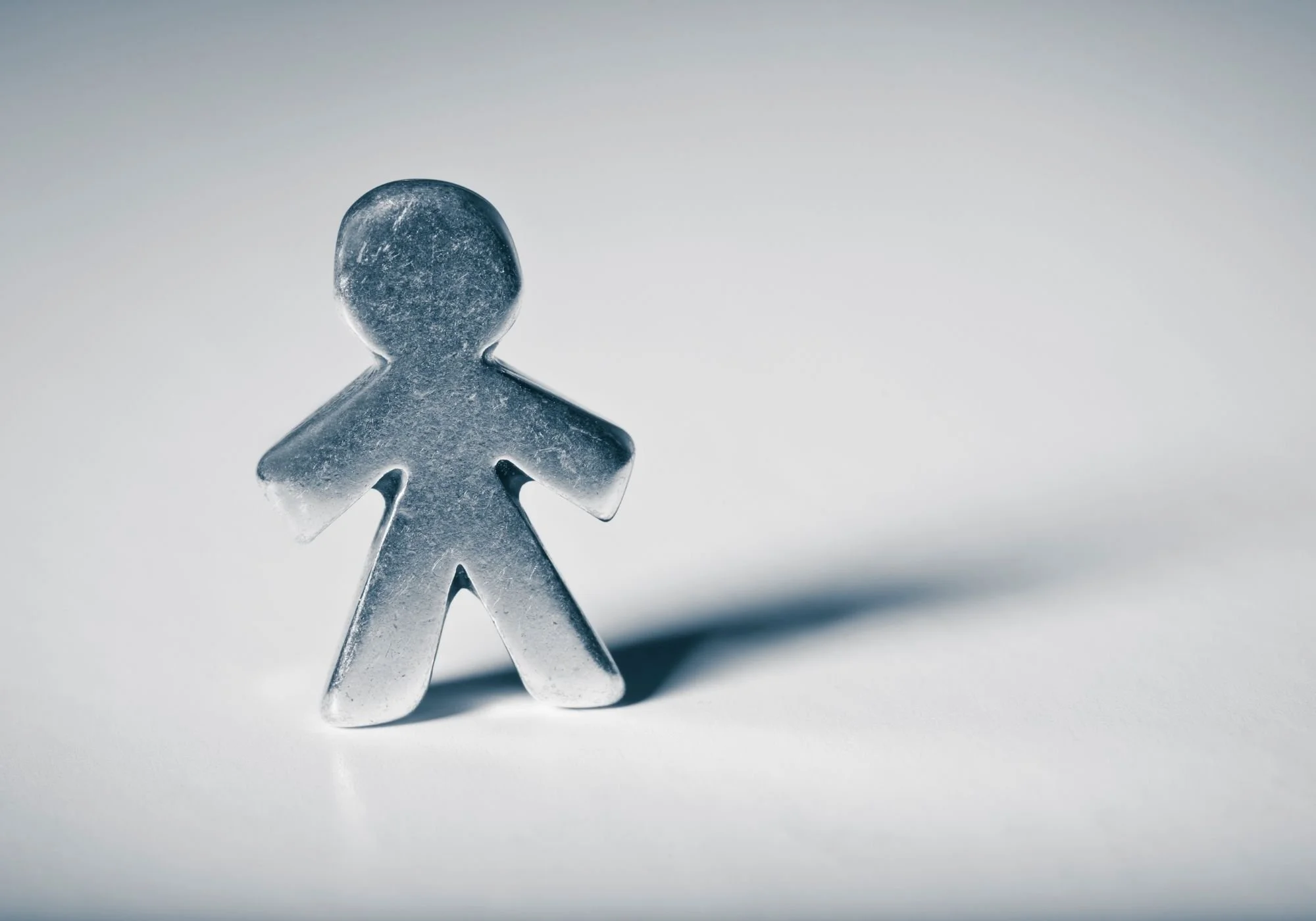 Close-up of a small, metallic, stylized human figure.