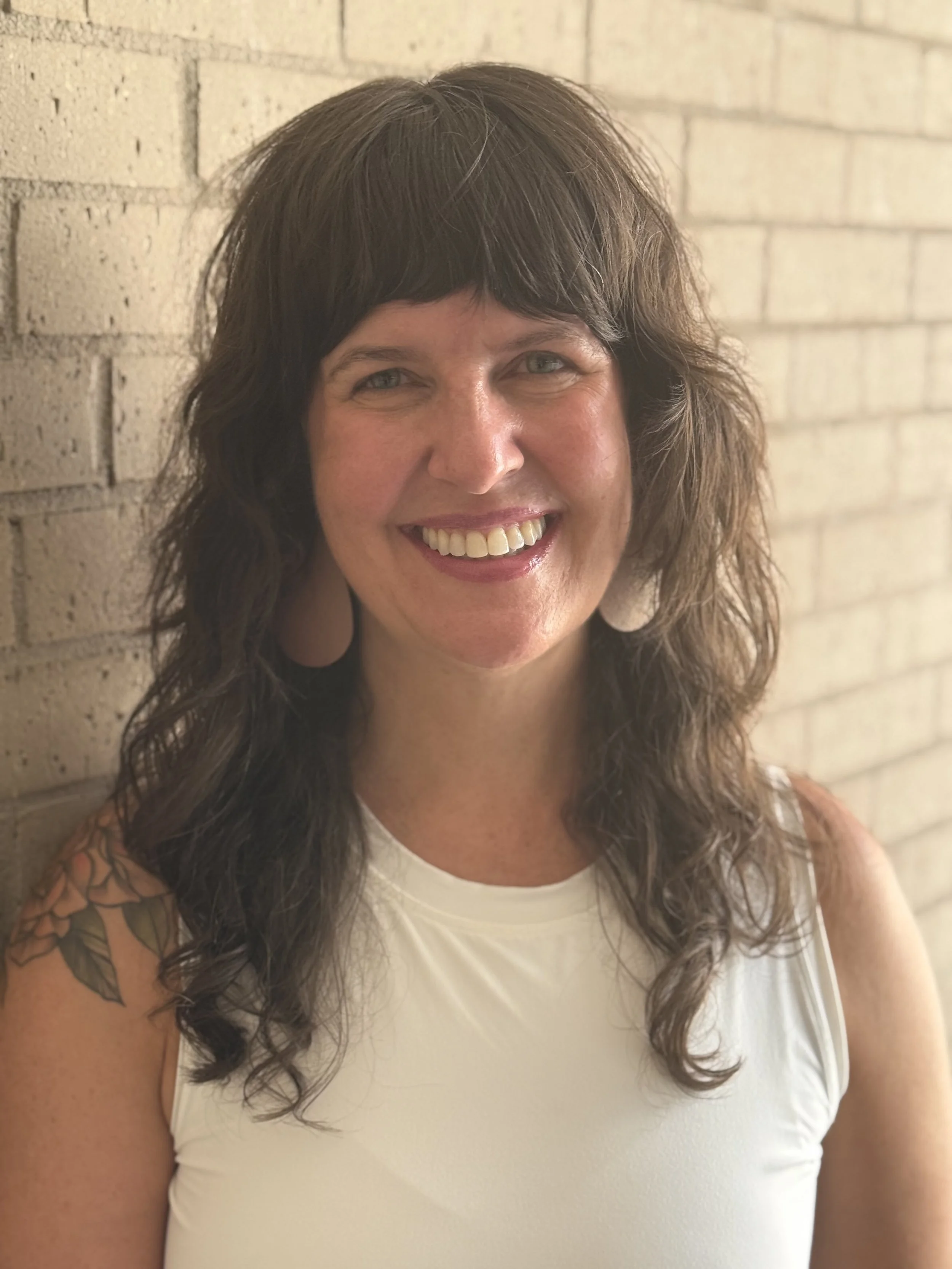 Kari, therapist and owner of Lofn Therapy, smiling in a white top — providing therapy in Little Canada, MN and telehealth across MN & WI