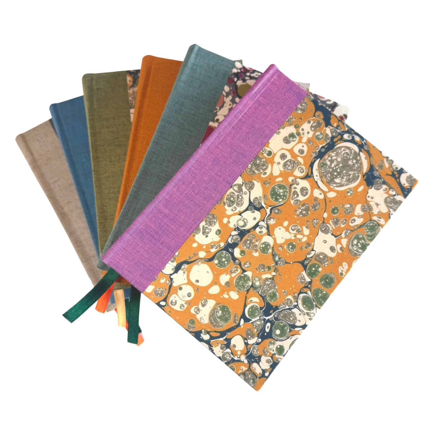 A collection of marbled and solid fabric swatches, some with ribbons attached, in various colors including beige, blue, green, orange, purple, and multicolored marbled patterns.