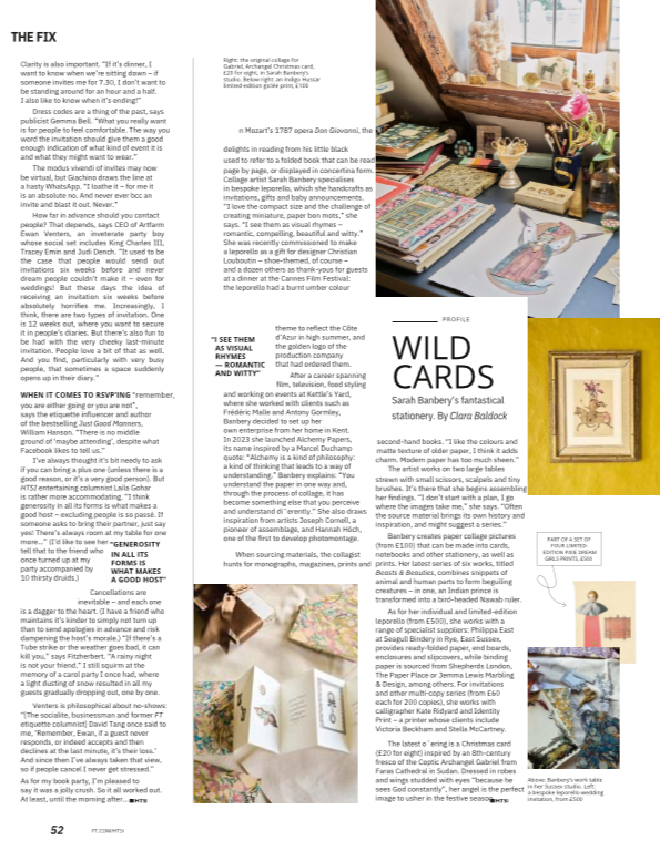 Image of a workspace with a table filled with art supplies, flowers, books, and framed artwork, including a portrait drawing of a religious figure and a landscape sketch, along with a laptop and decorative objects.