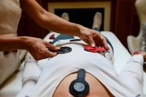 Practitioner performing a Biomagnetic Pair Therapy session with a client