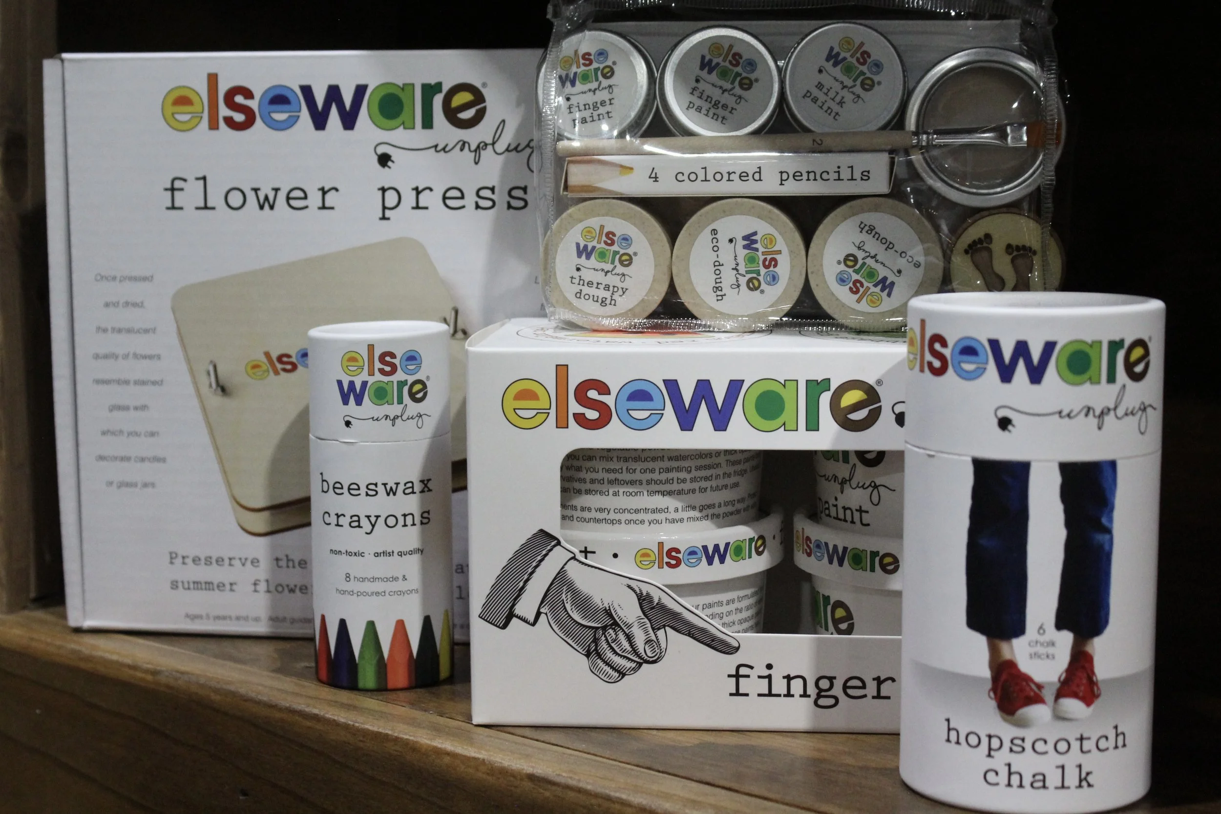 Elseware art supplies including a finger puppet craft kit, four colored pencils, beeswax crayons, and hopscotch chalk at Burley Sustainable General Store in West Jefferson, NC.