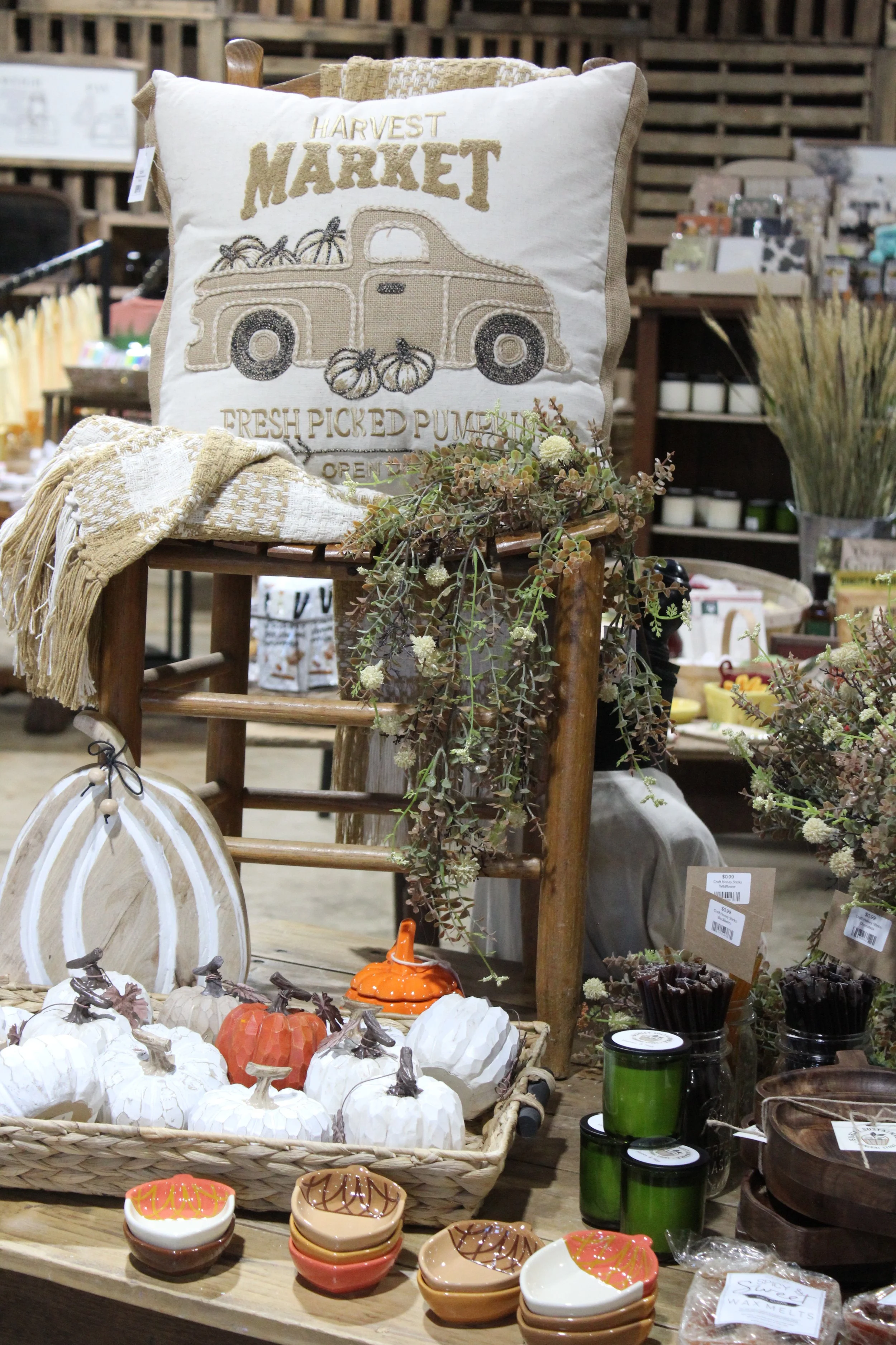 Display of decorative pumpkins, small bowls, candles, and fall-themed items at Burley Sustainable General Store in West Jefferson, NC.