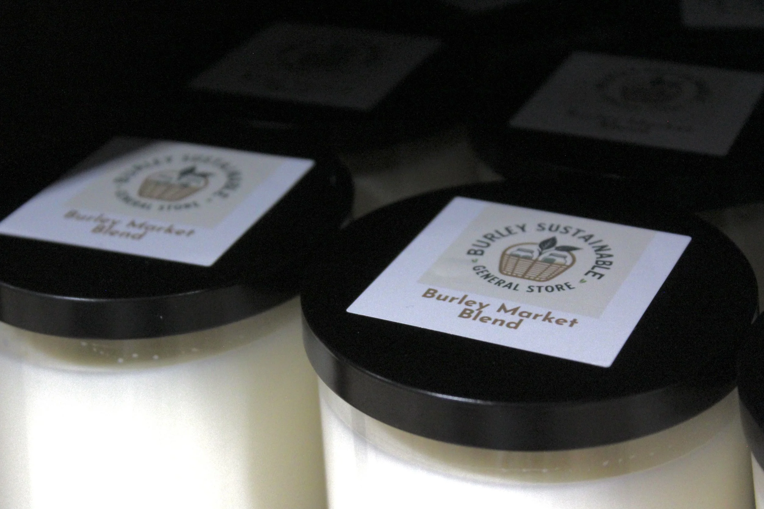 Custom "Burley Market Blend" and "Burley Sustainable General Store" organic candles.