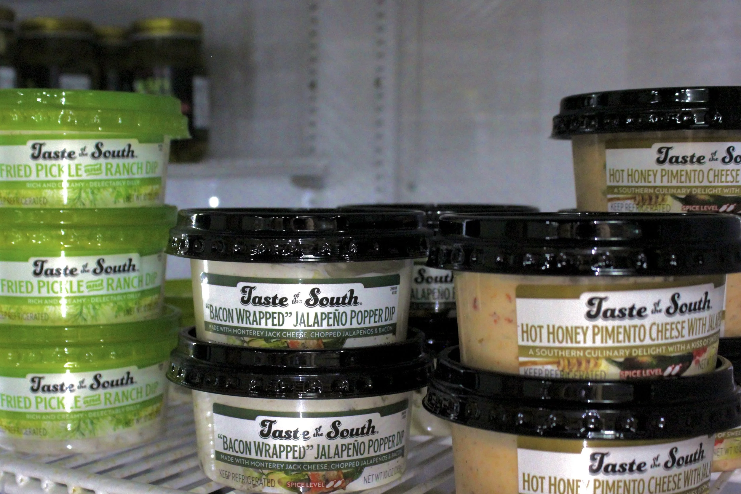 Taste of the South dips on store shelves, including fried pickle ranch dip, bacon-wrapped jalapeño pepper dip, and hot honey pimento cheese.