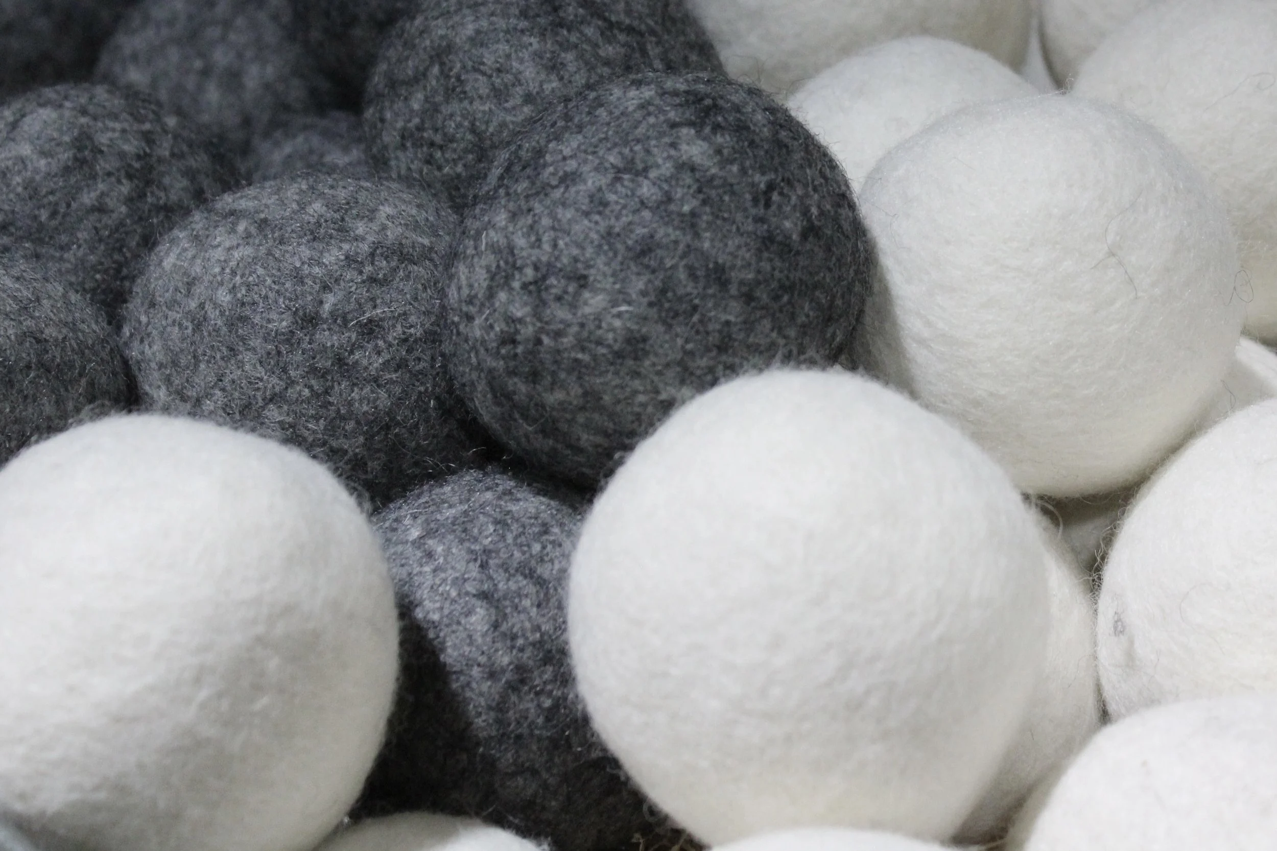 wool dryer balls in white, gray, and black at Burley Sustainable General Store in West Jefferson, NC.
