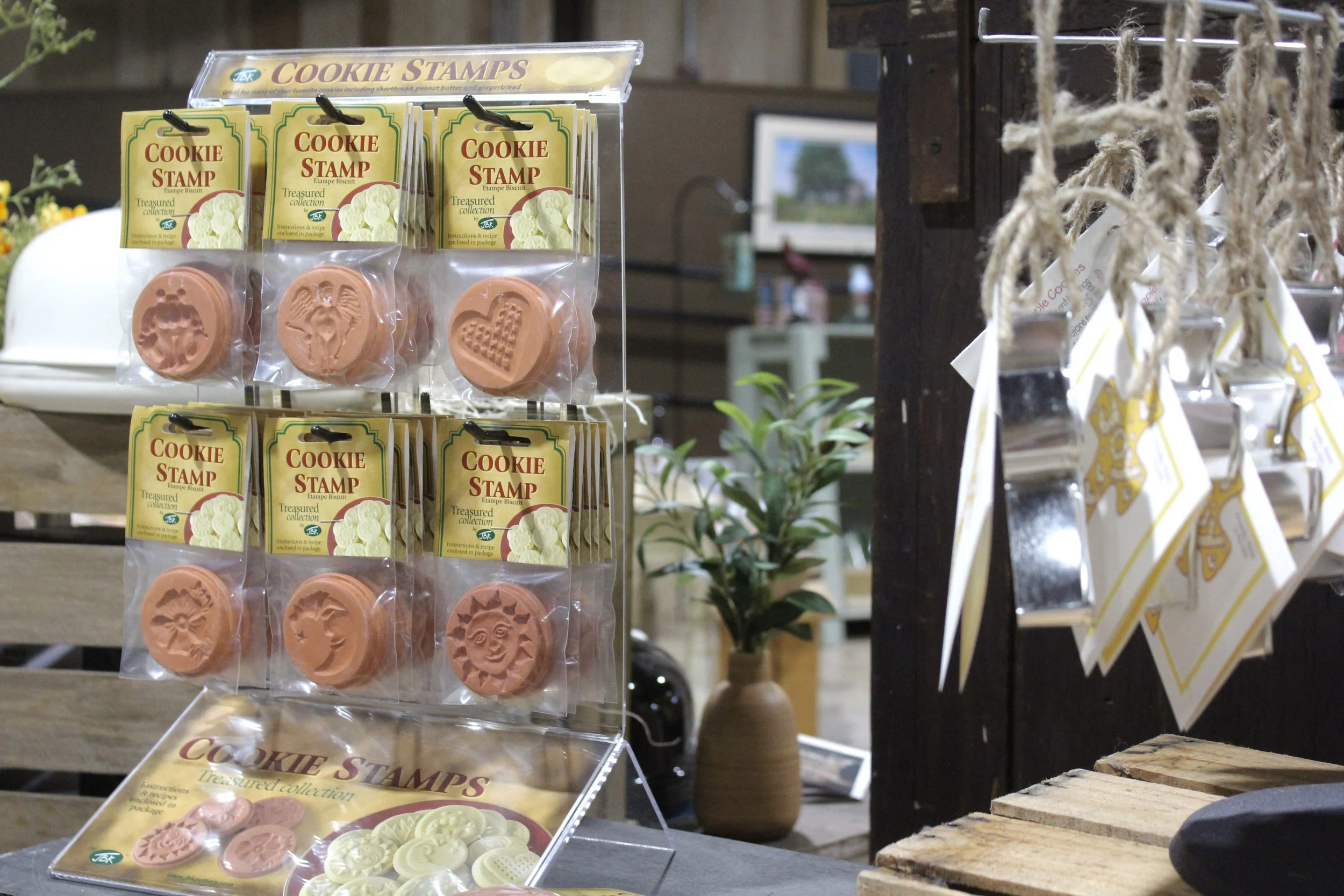 Display of cookie stamps and cookies at Burley Sustainable General Store in West Jefferson, NC, with packages labeled 'Cookie Stamp' showing various cookie shapes.