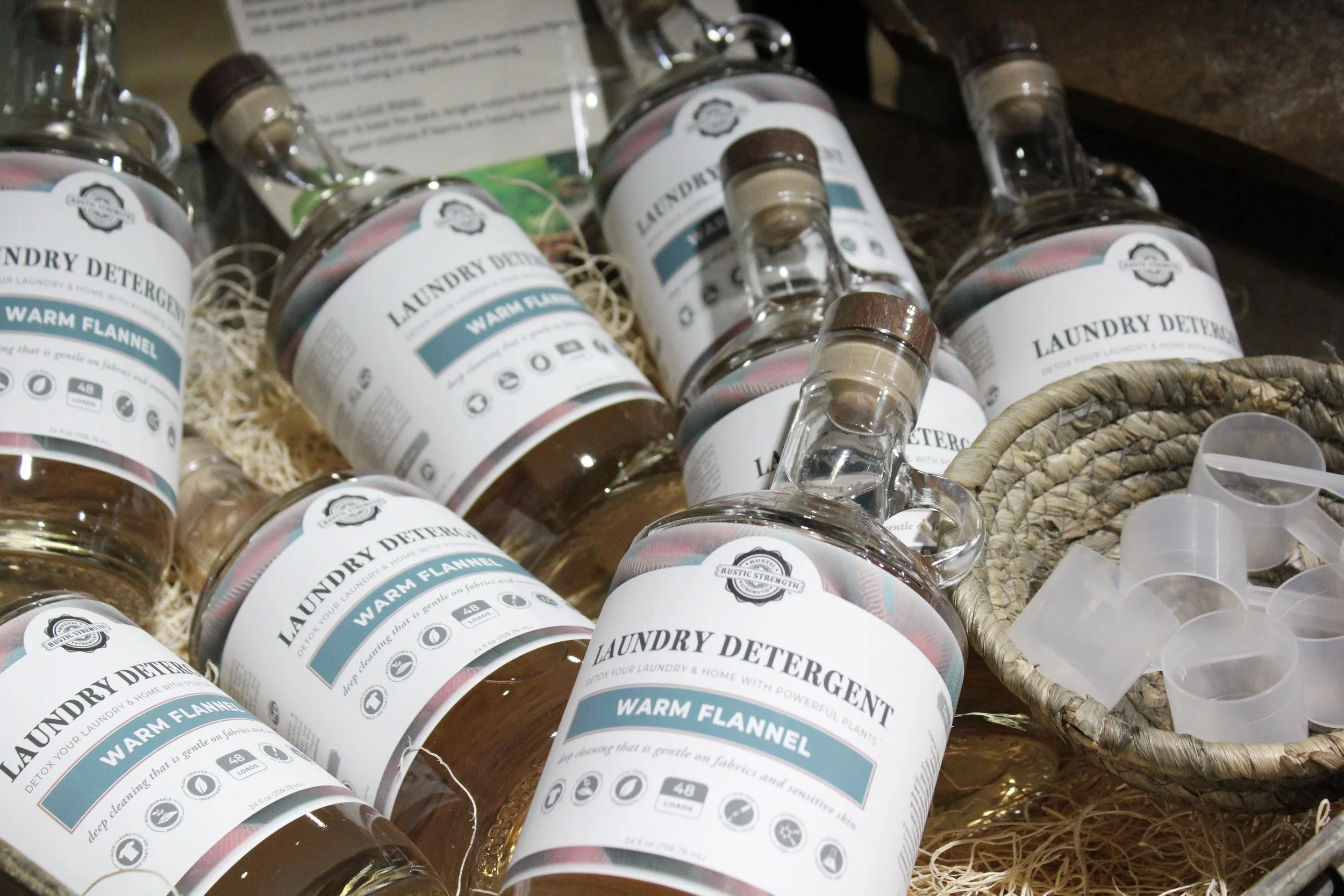 Several bottles of organic laundry detergent labeled "Warm Flannel" in a basket at Burley Sustainable General Store in West Jefferson, NC.