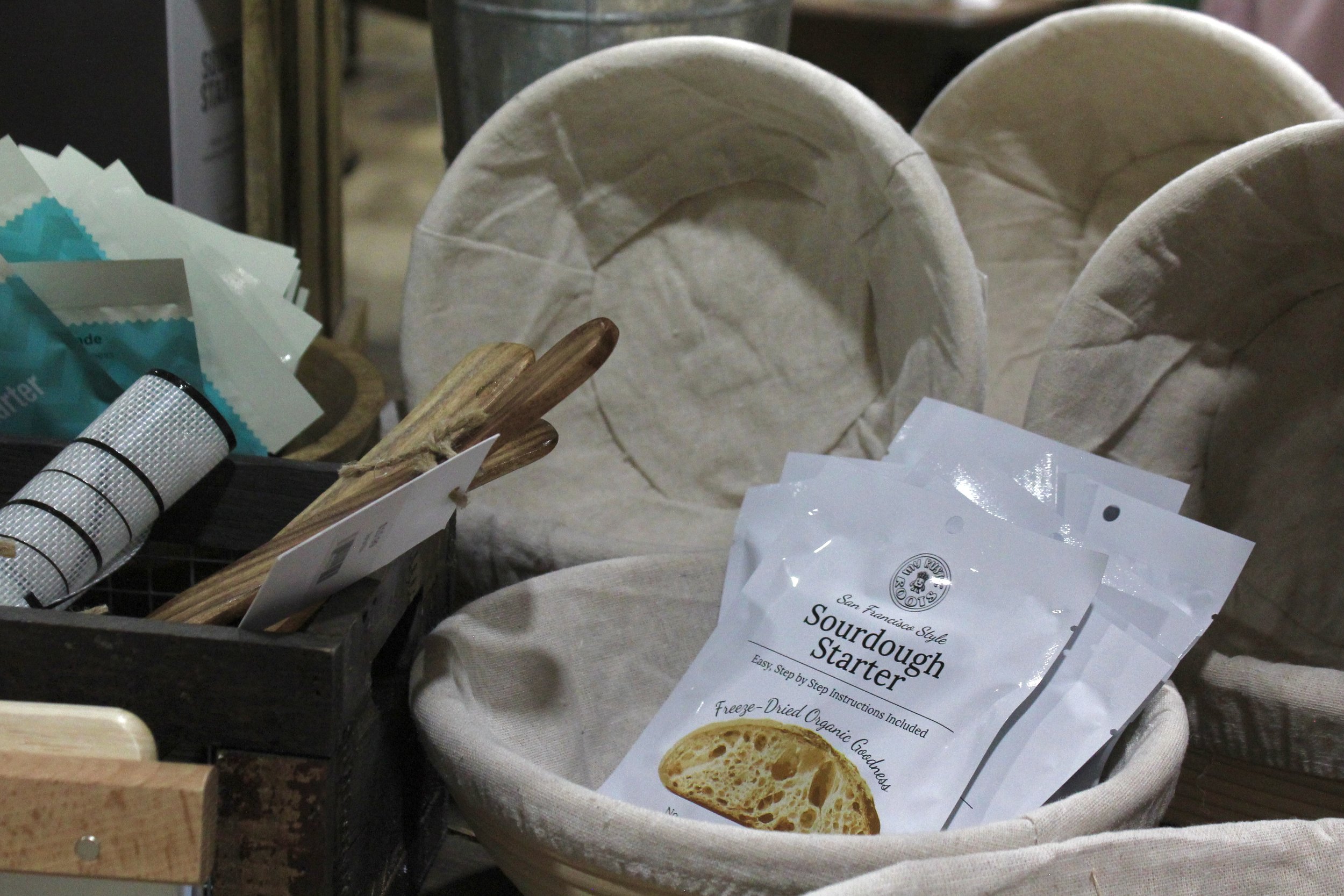 A basket containing packs of sourdough starter and a loaf of bread at Burley Sustainable General Store in West Jefferson, NC.