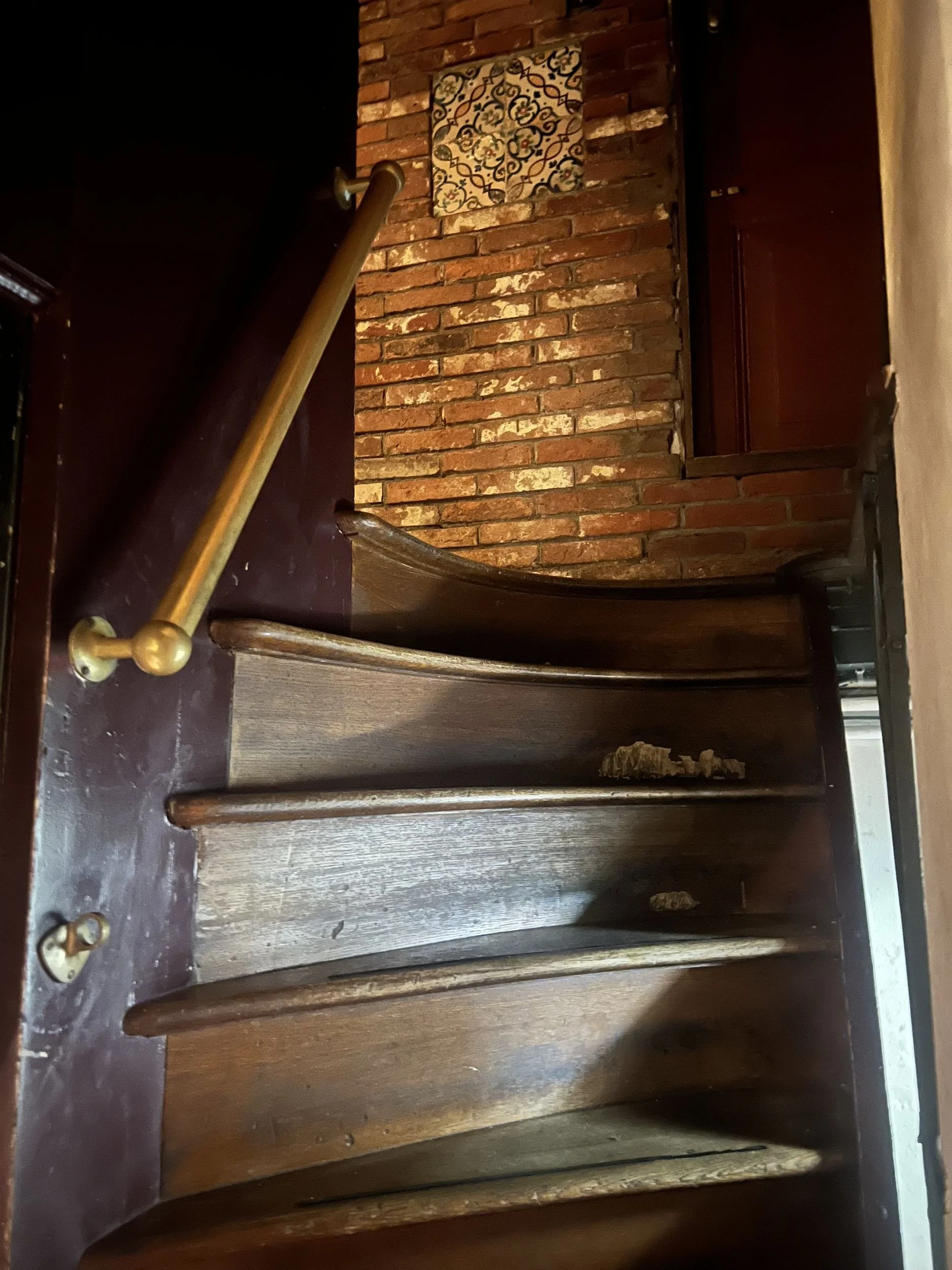 Steep spiral wooden staircase inside a 17th-century Amsterdam house