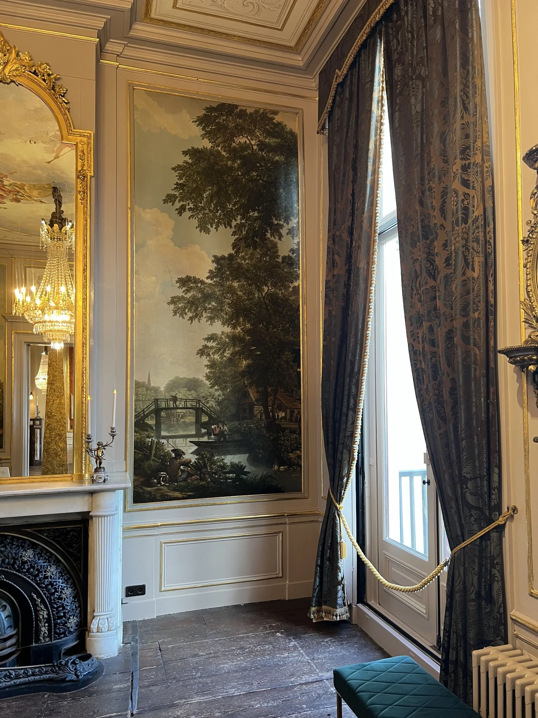 Period room with painted wall panels and tall windows in an Amsterdam canal house