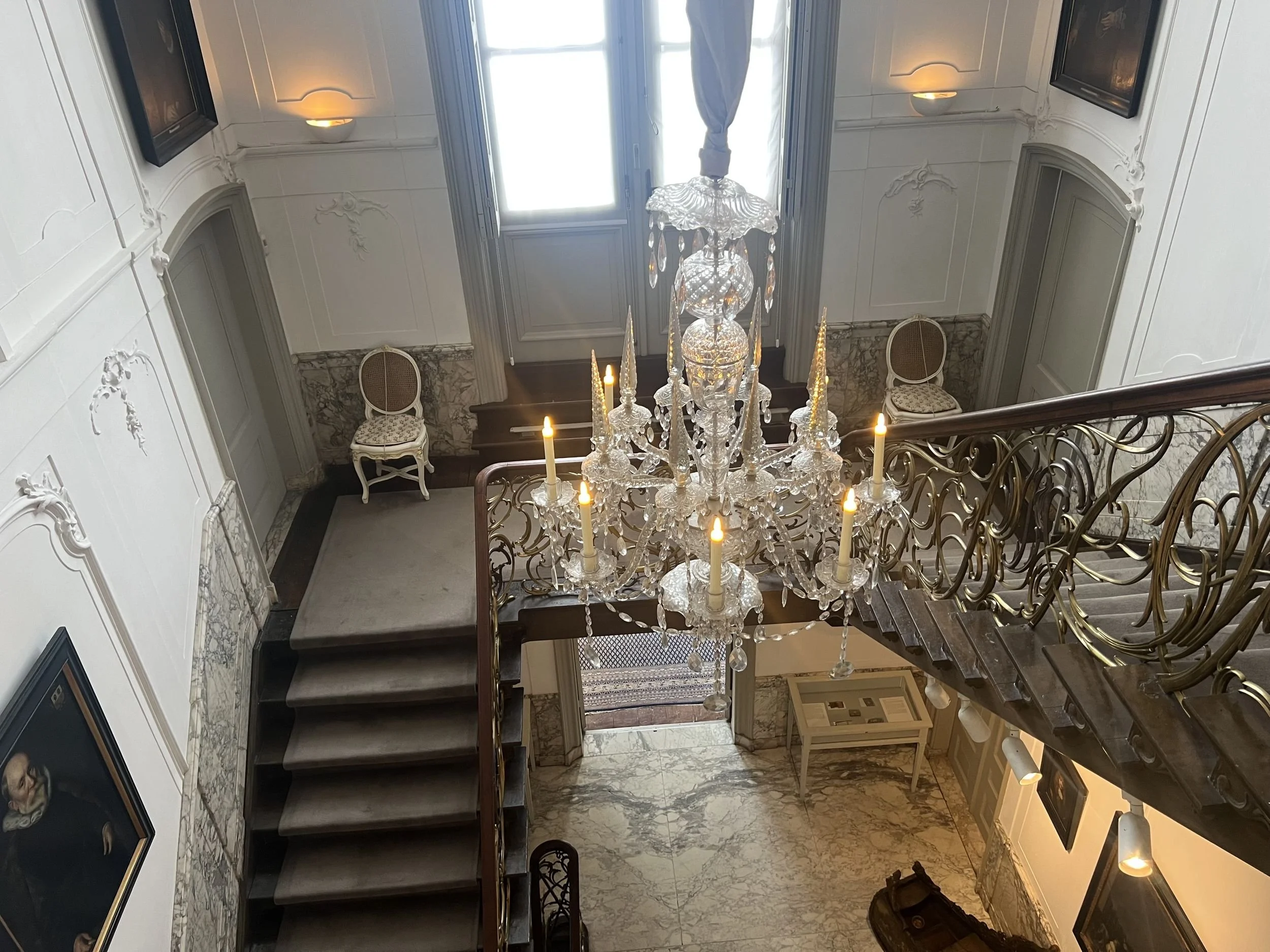 Marble staircase and crystal chandelier inside a historic Amsterdam canal house