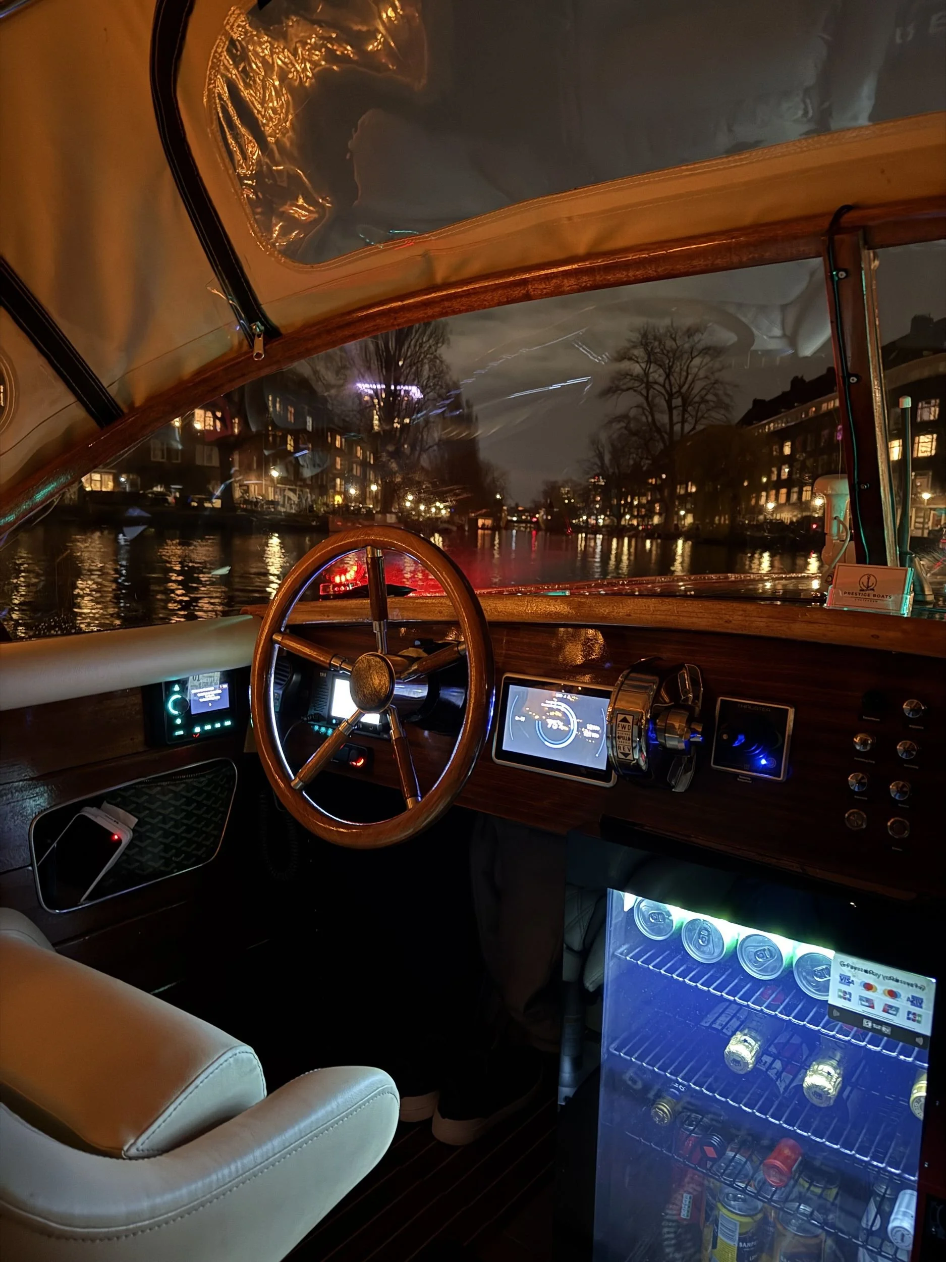 Helm of a private canal boat during an evening corporate cruise in Amsterdam