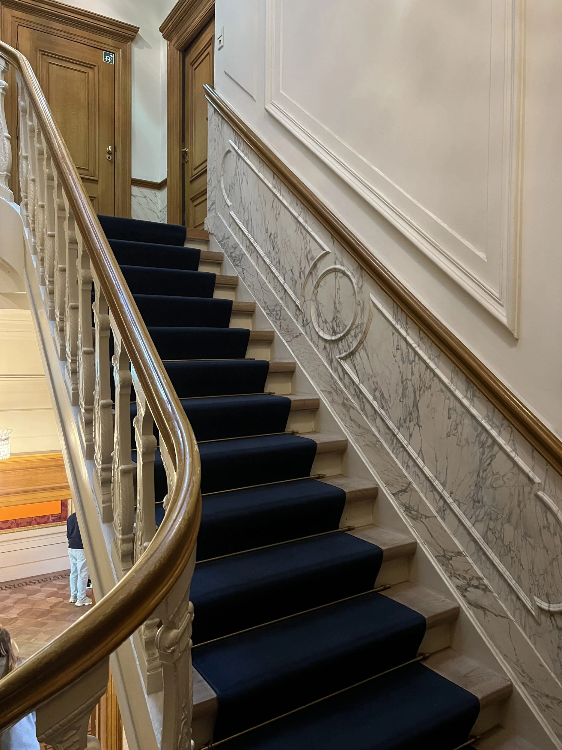 Carpeted staircase with carved banister in an Amsterdam canal house