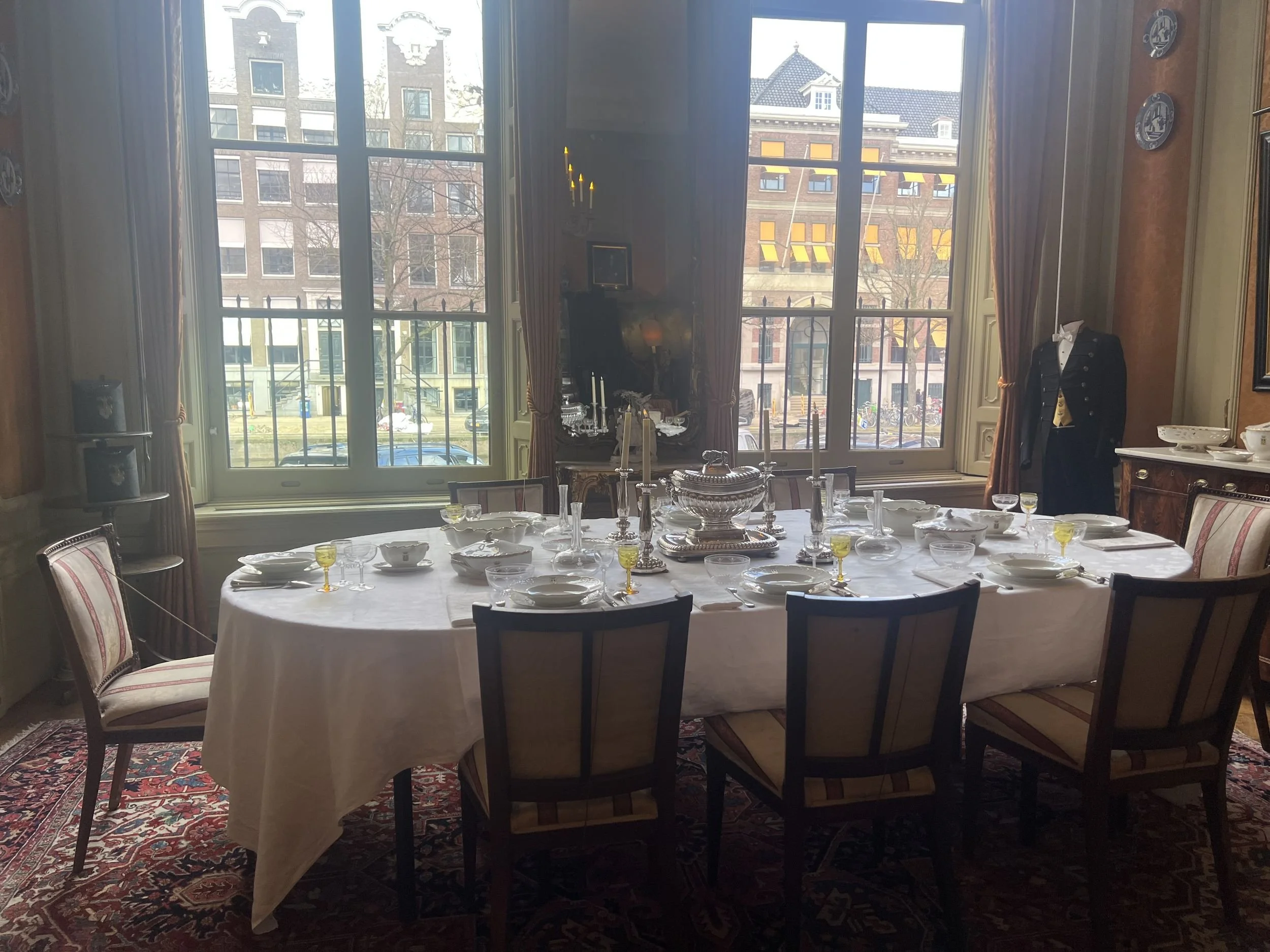 Table set for a private dinner in a period dining room overlooking an Amsterdam canal