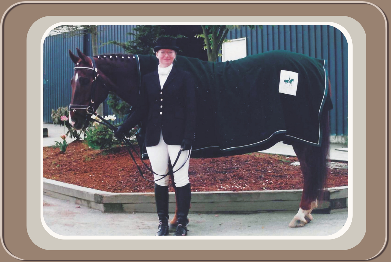 A person dressed in equestrian attire standing next to a horse covered with a blanket. Linda Anne Starr | Training the Horse's Beautiful Mind