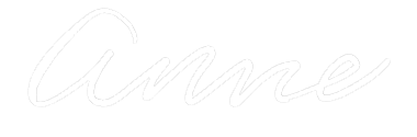 Stylized signature of the name 'Anne' in white text on a black background.