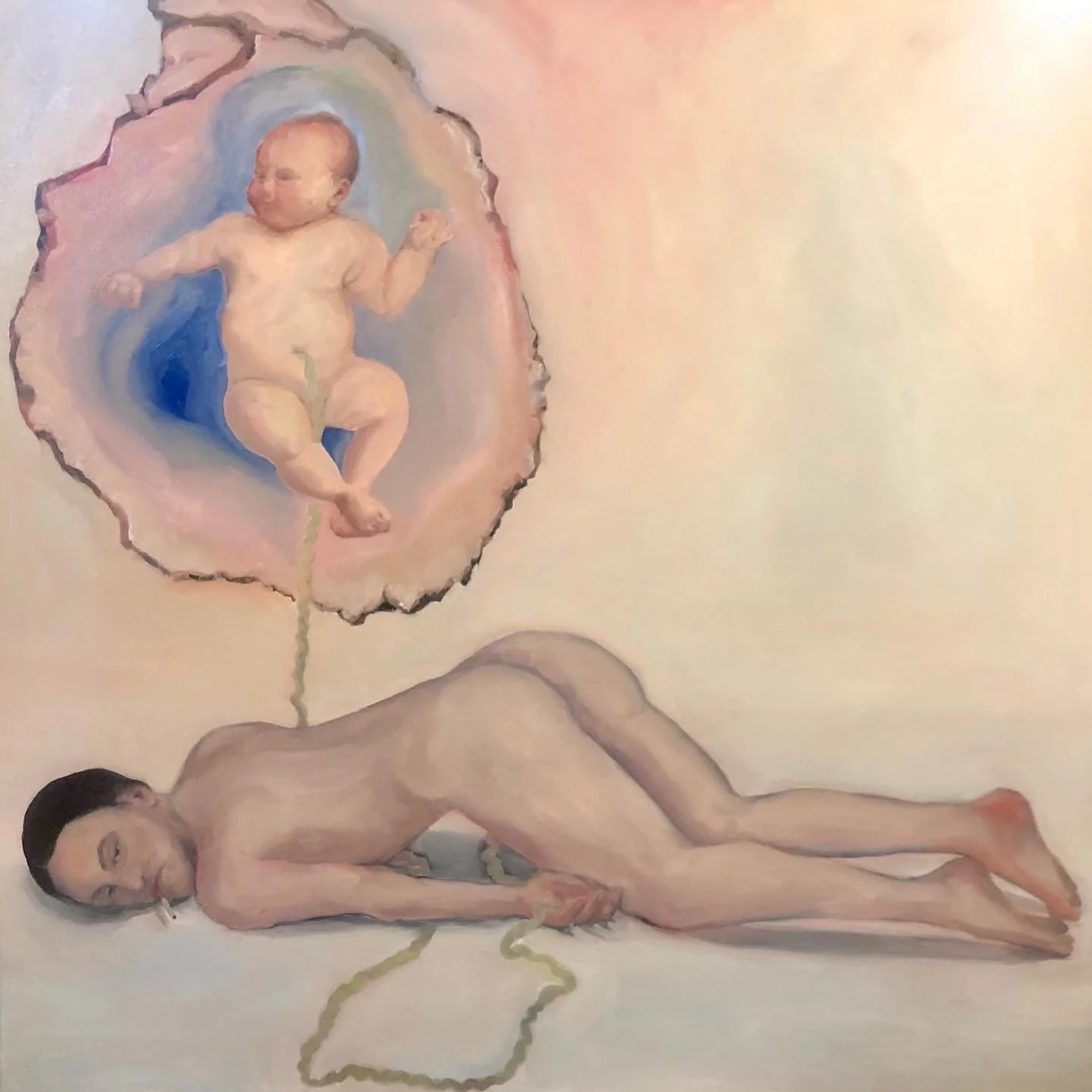 A nude woman lying on her side with eyes closed, with a realistic painting of a sleeping baby emerging from her shoulder, connected by a greenish cord, within a pastel-colored background.