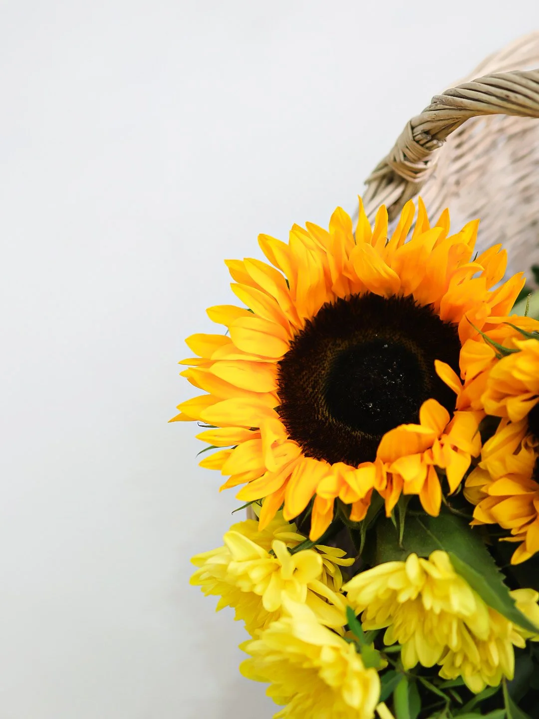 A sunflower bouquet in a wicker basket