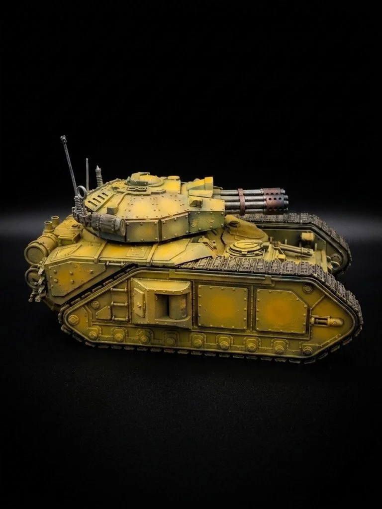Model of a yellow military tank on a black background.