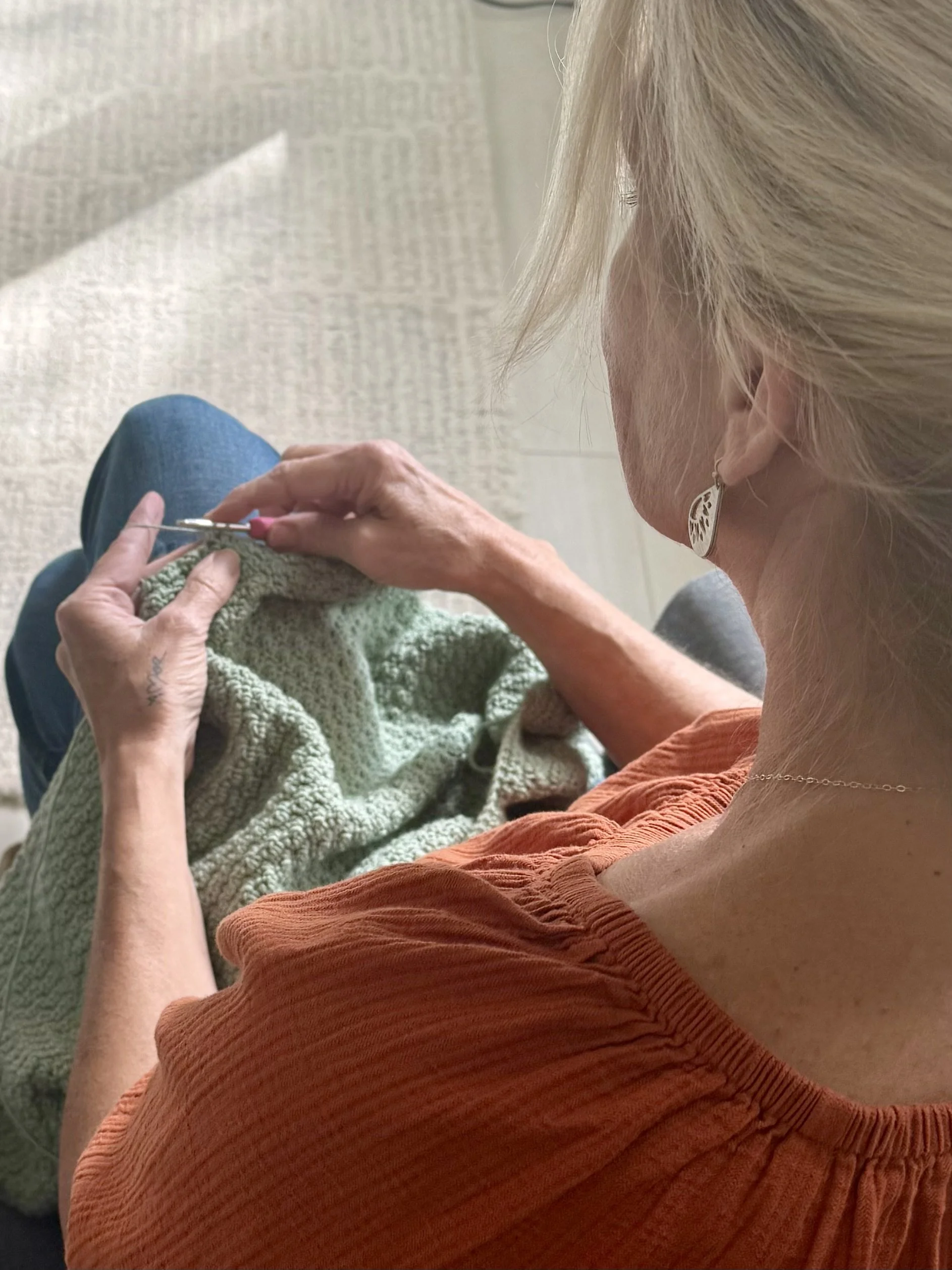 Tessa Smith crocheting her most recent cardigan pattern design.