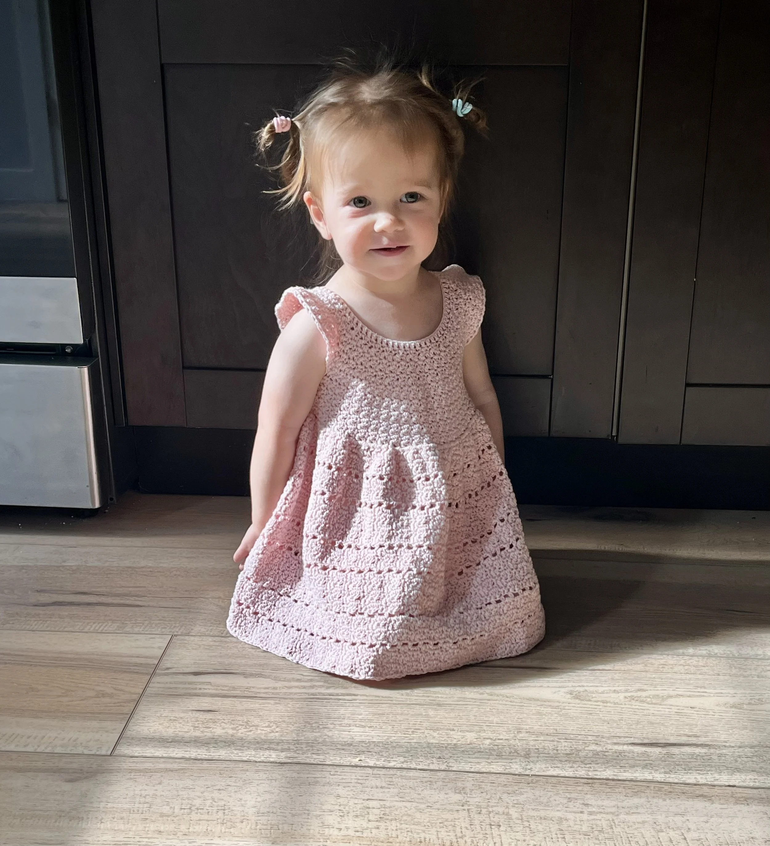 A child wearing the Daydream Dress created by Tessa Smith Designs.