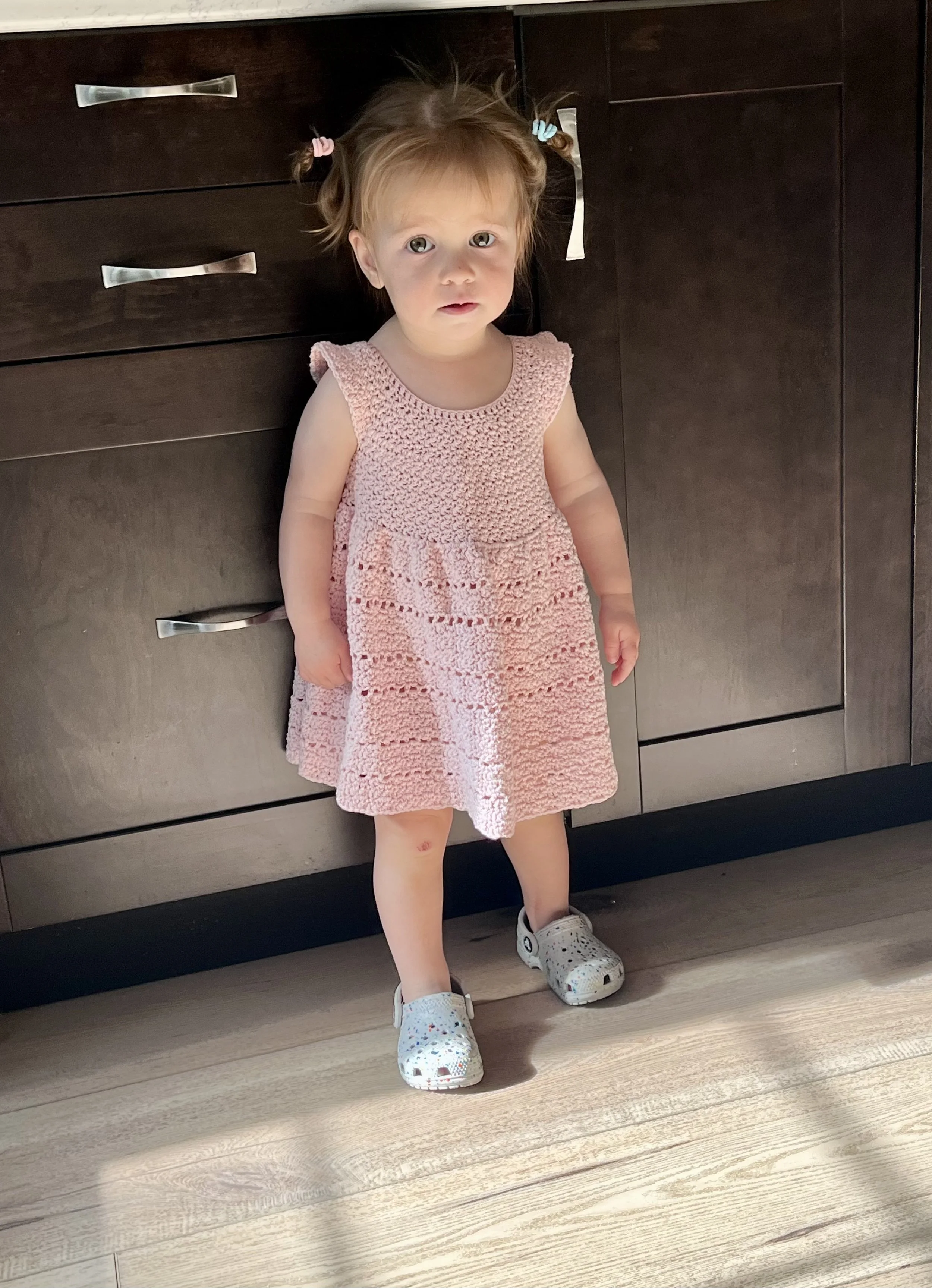 A child wearing the Daydream Dress created by Tessa Smith Designs.